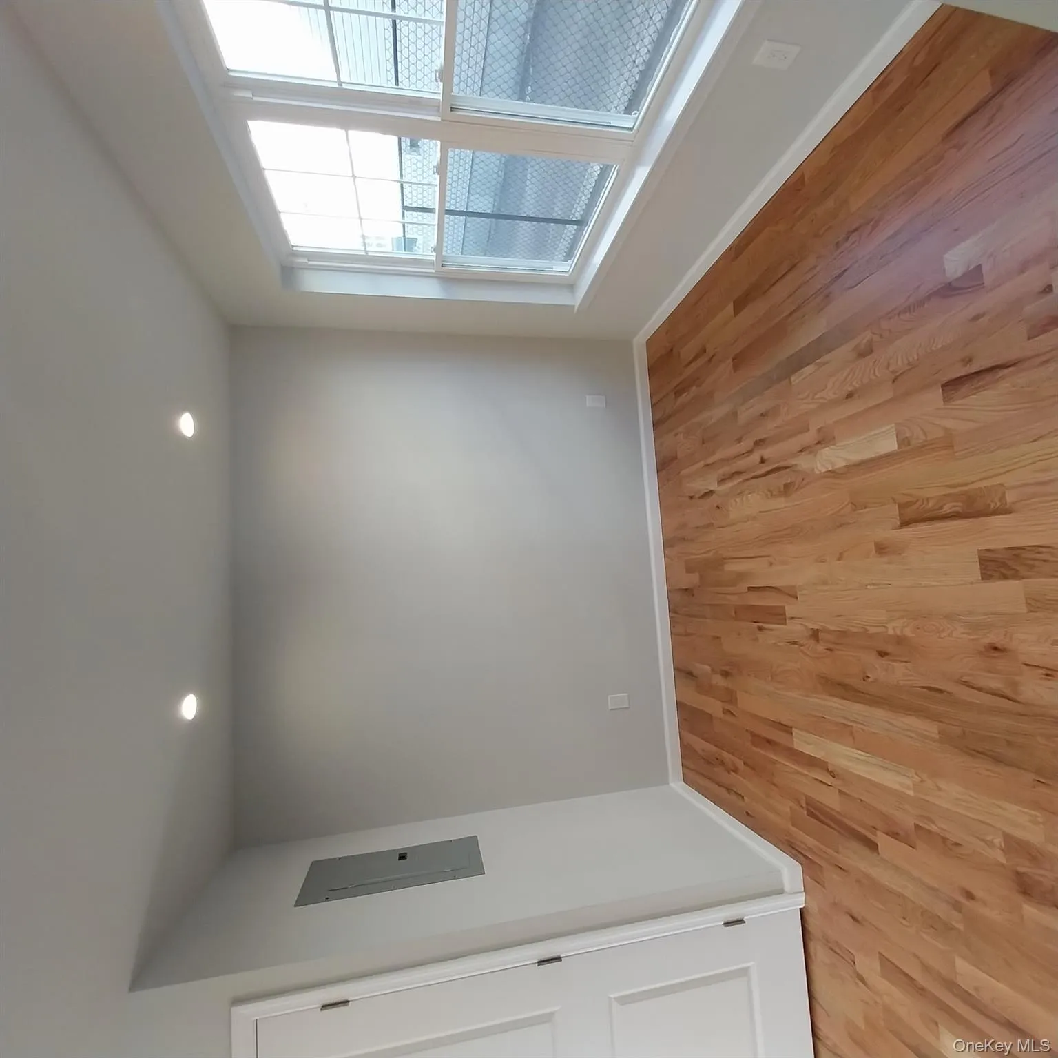 Unfurnished room featuring light wood-type flooring, electric panel, and recessed lighting Unfurnished room featuring light wood-type flooring, electric panel, and recessed lighting