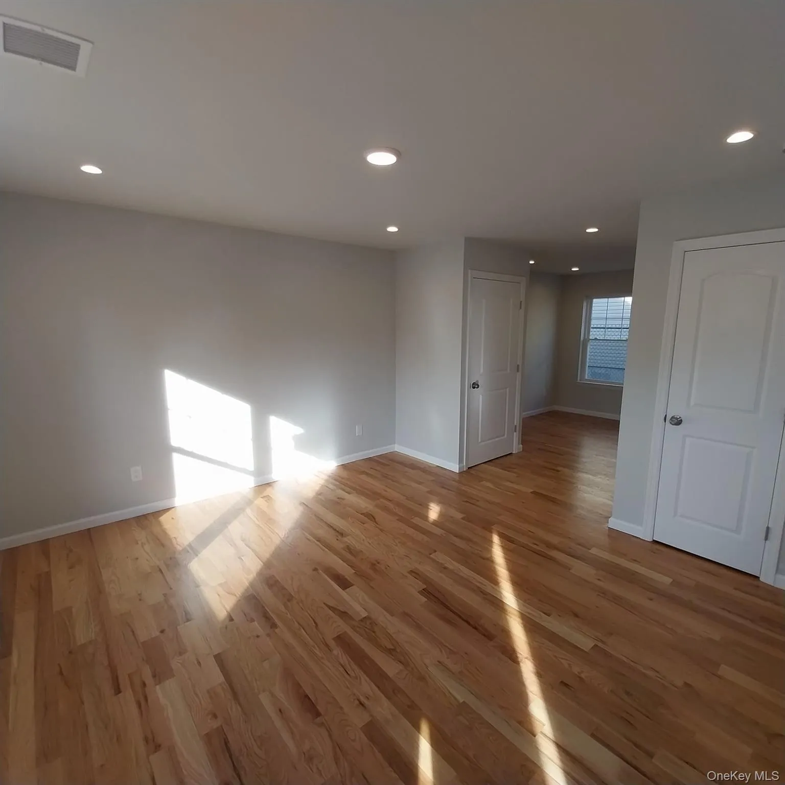 Empty room with light wood-style flooring and recessed lighting Empty room with light wood-style flooring and recessed lighting