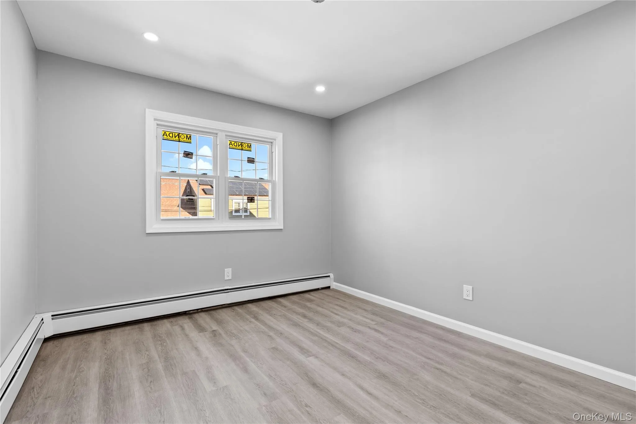 Spare room featuring light wood-type flooring, baseboard heating, and recessed lighting Spare room featuring light wood-type flooring, baseboard heating, and recessed lighting