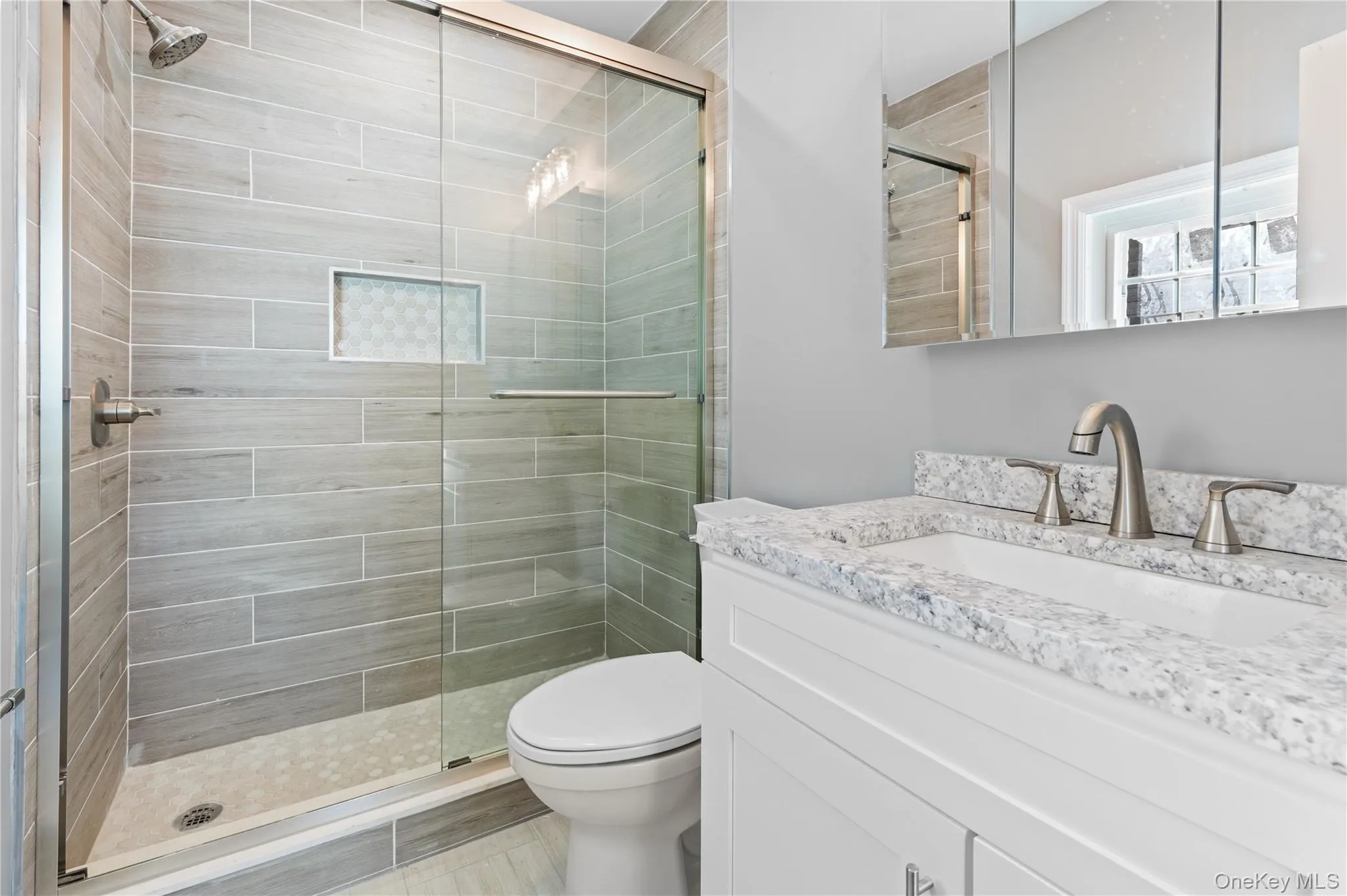 Bathroom featuring a stall shower and vanity Bathroom featuring a stall shower and vanity