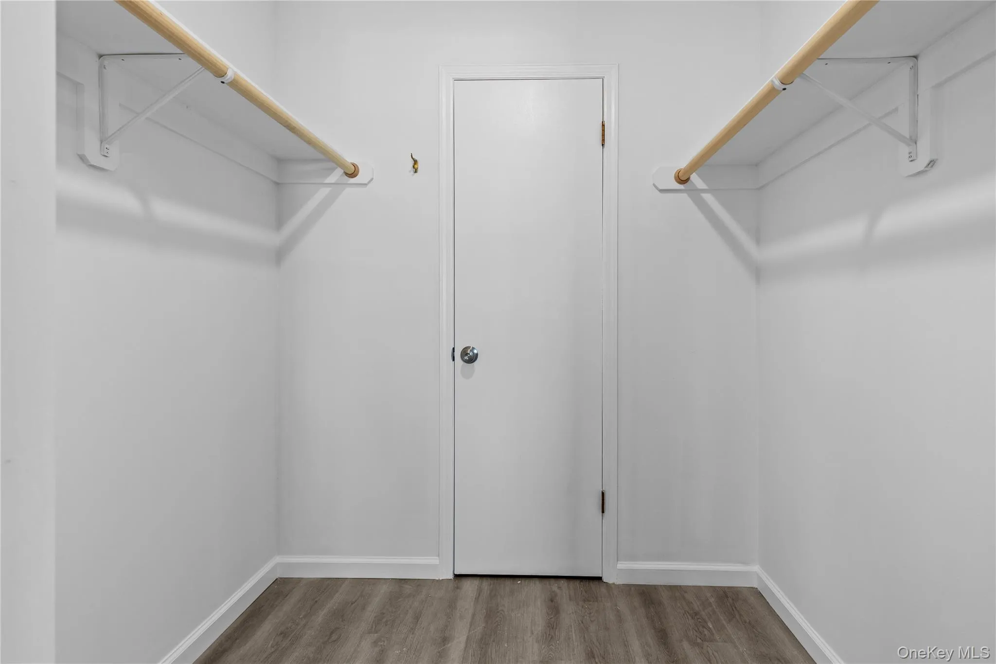 Spacious closet featuring light wood-style flooring Spacious closet featuring light wood-style flooring