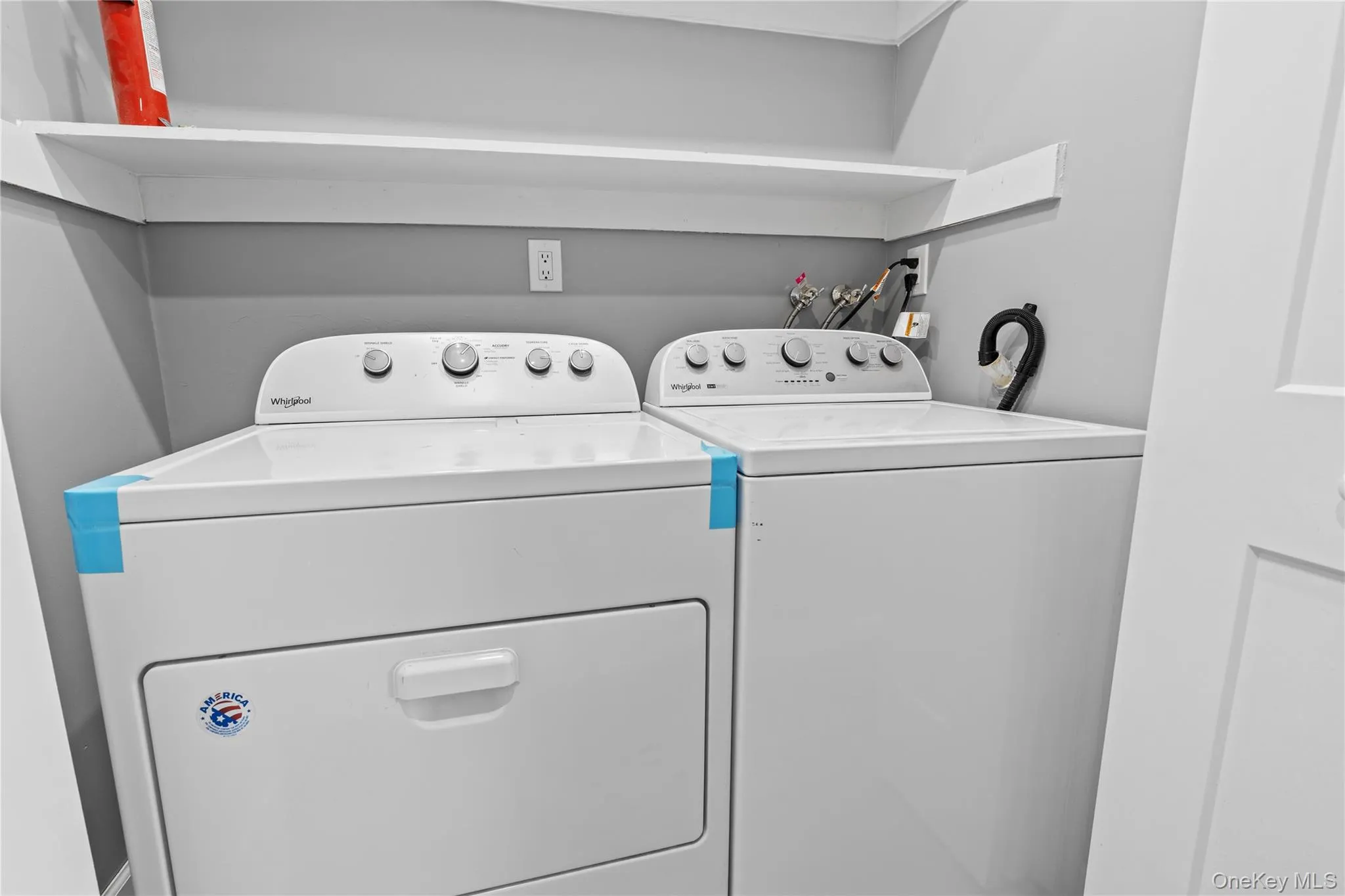 Washroom with washer and clothes dryer Washroom with washer and clothes dryer