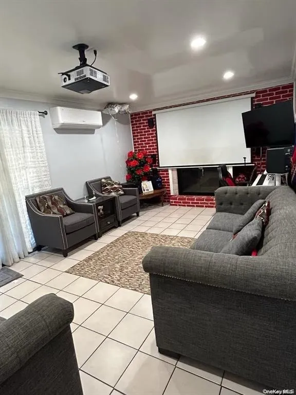 Home theater room featuring crown molding, light tile patterned floors, and recessed lighting Home theater room featuring crown molding, light tile patterned floors, and recessed lighting