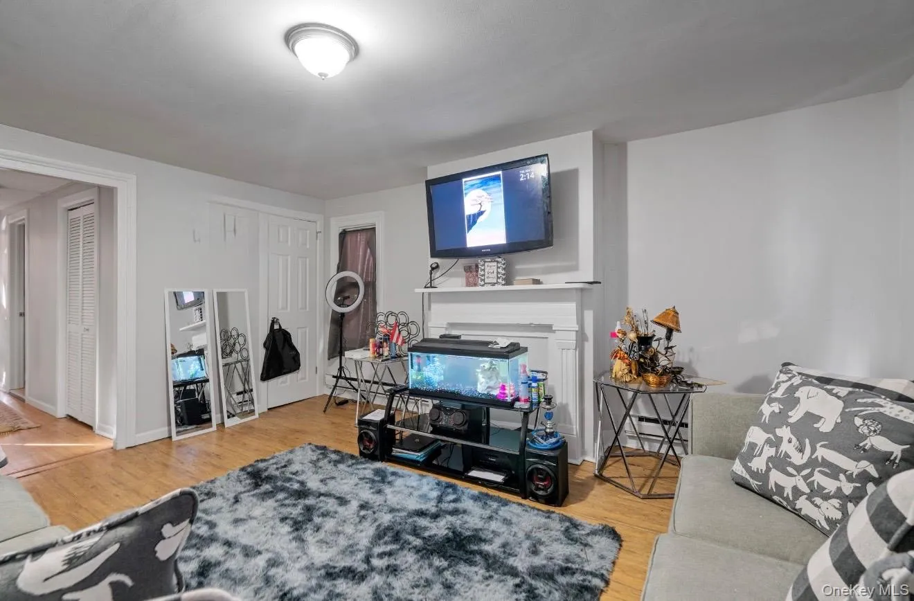 Living area featuring light wood-style floors and baseboards Living area featuring light wood-style floors and baseboards