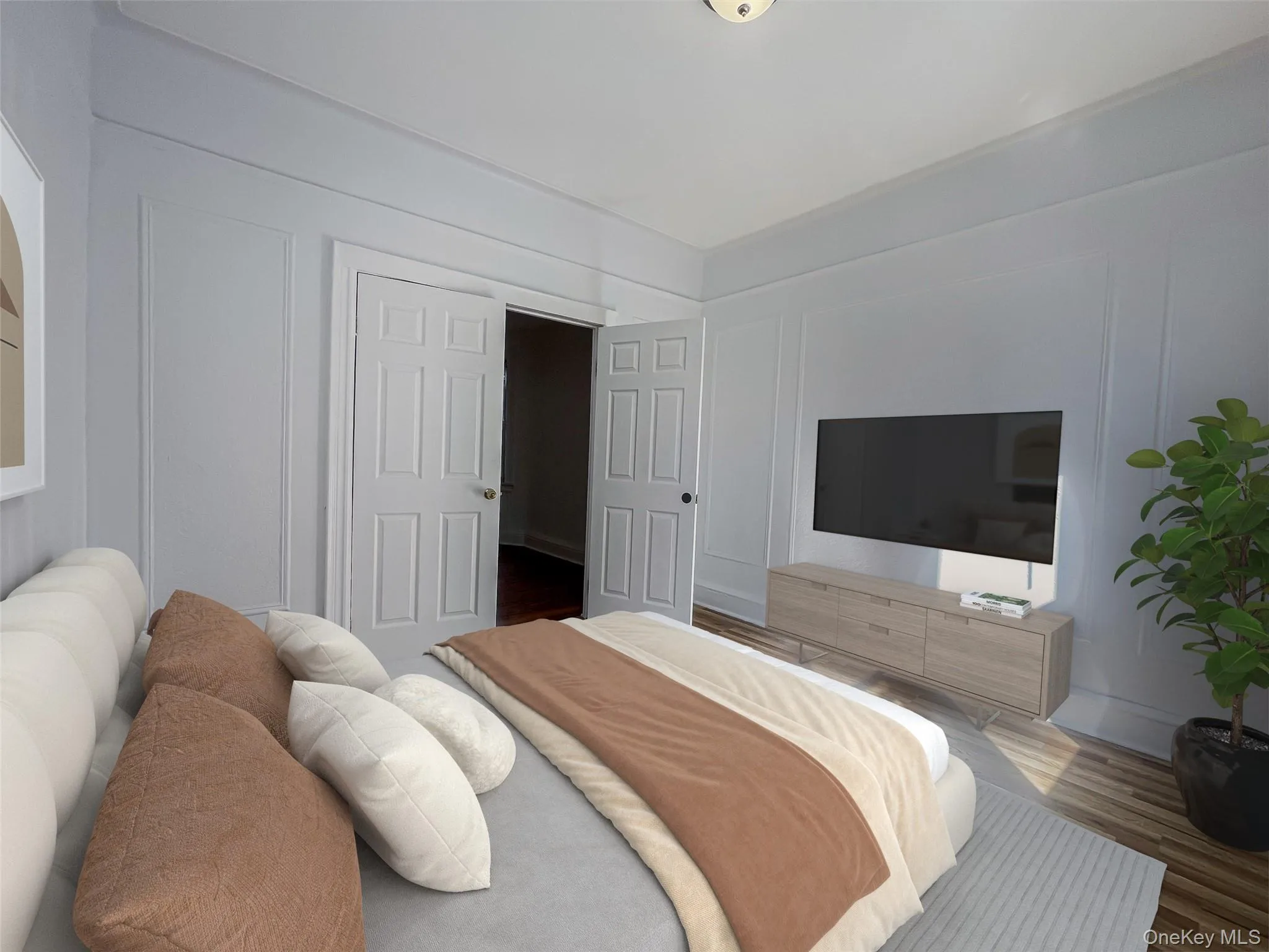 Bedroom featuring a decorative wall and wood finished floors Bedroom featuring a decorative wall and wood finished floors