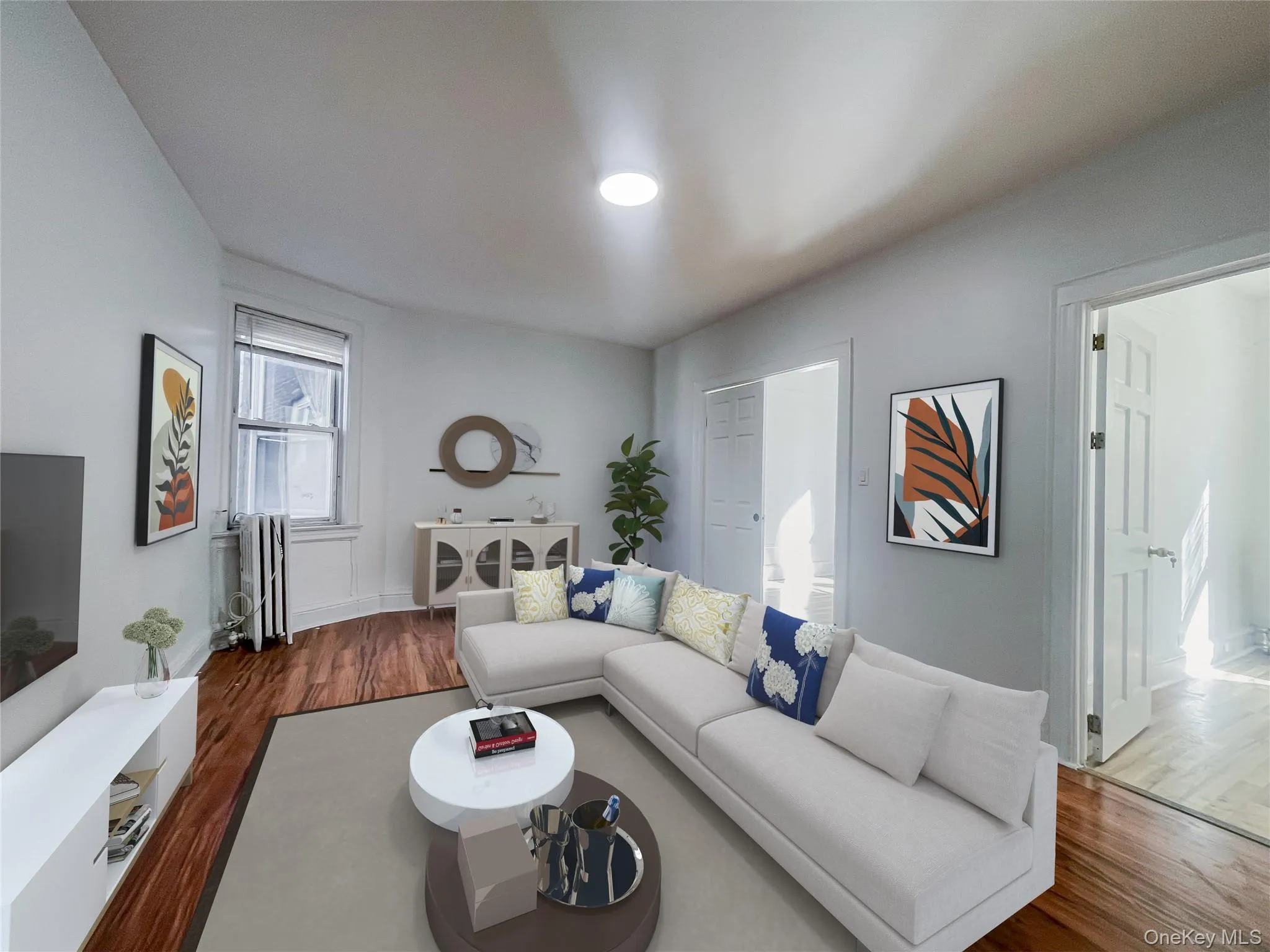 Living room featuring wood finished floors and radiator Living room featuring wood finished floors and radiator
