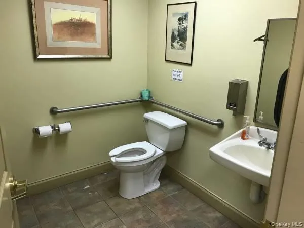Half bathroom featuring toilet and baseboards Half bathroom featuring toilet and baseboards