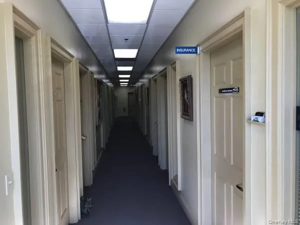 Corridor featuring a drop ceiling Corridor featuring a drop ceiling