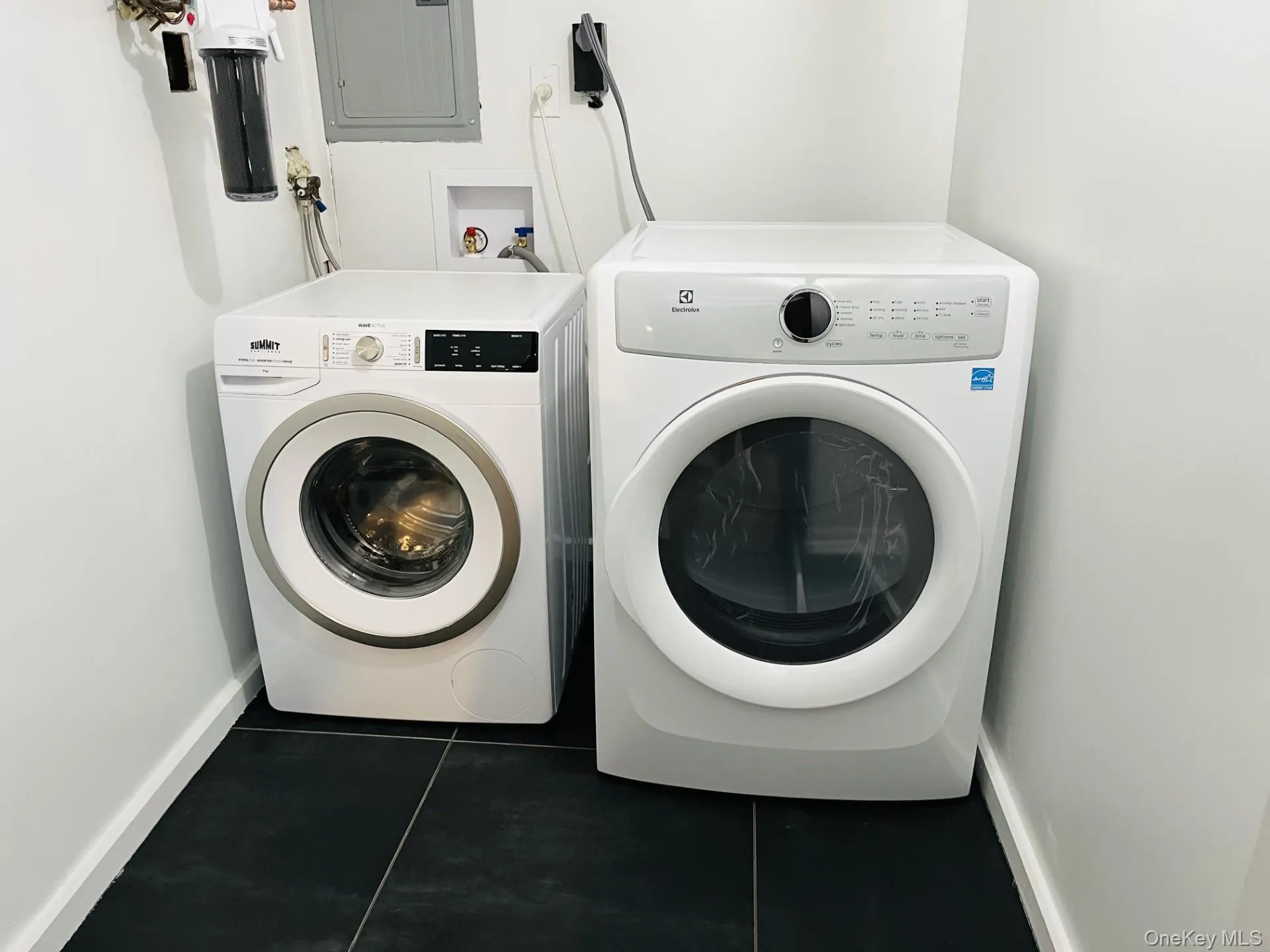 Laundry area with tile floor, and new washer and dryer Laundry area with tile floor, and new washer and dryer