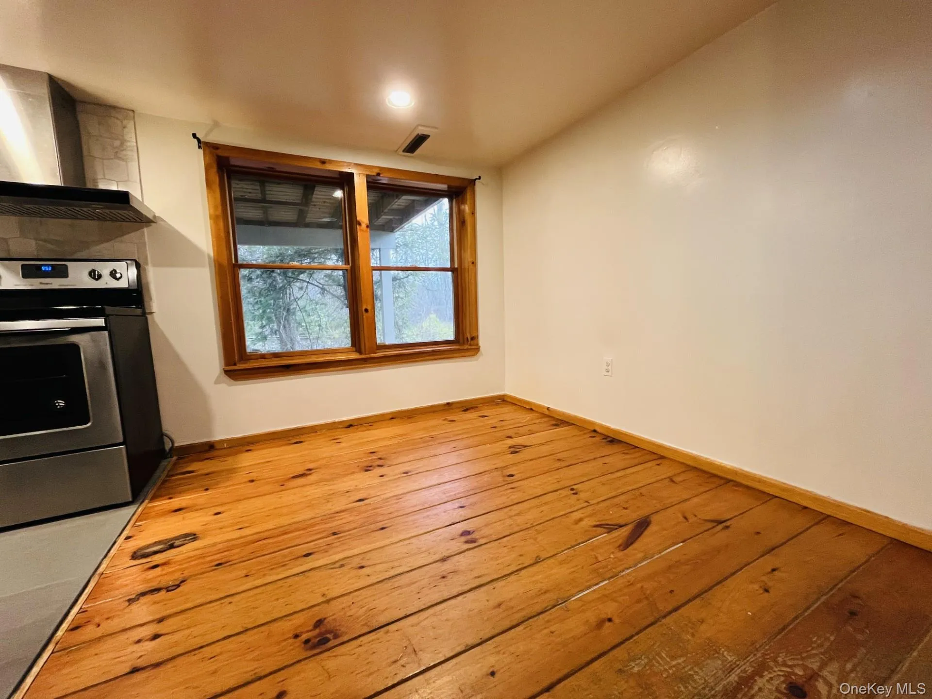 Dining area featuring wood flooring and recessed lighting Dining area featuring wood flooring and recessed lighting
