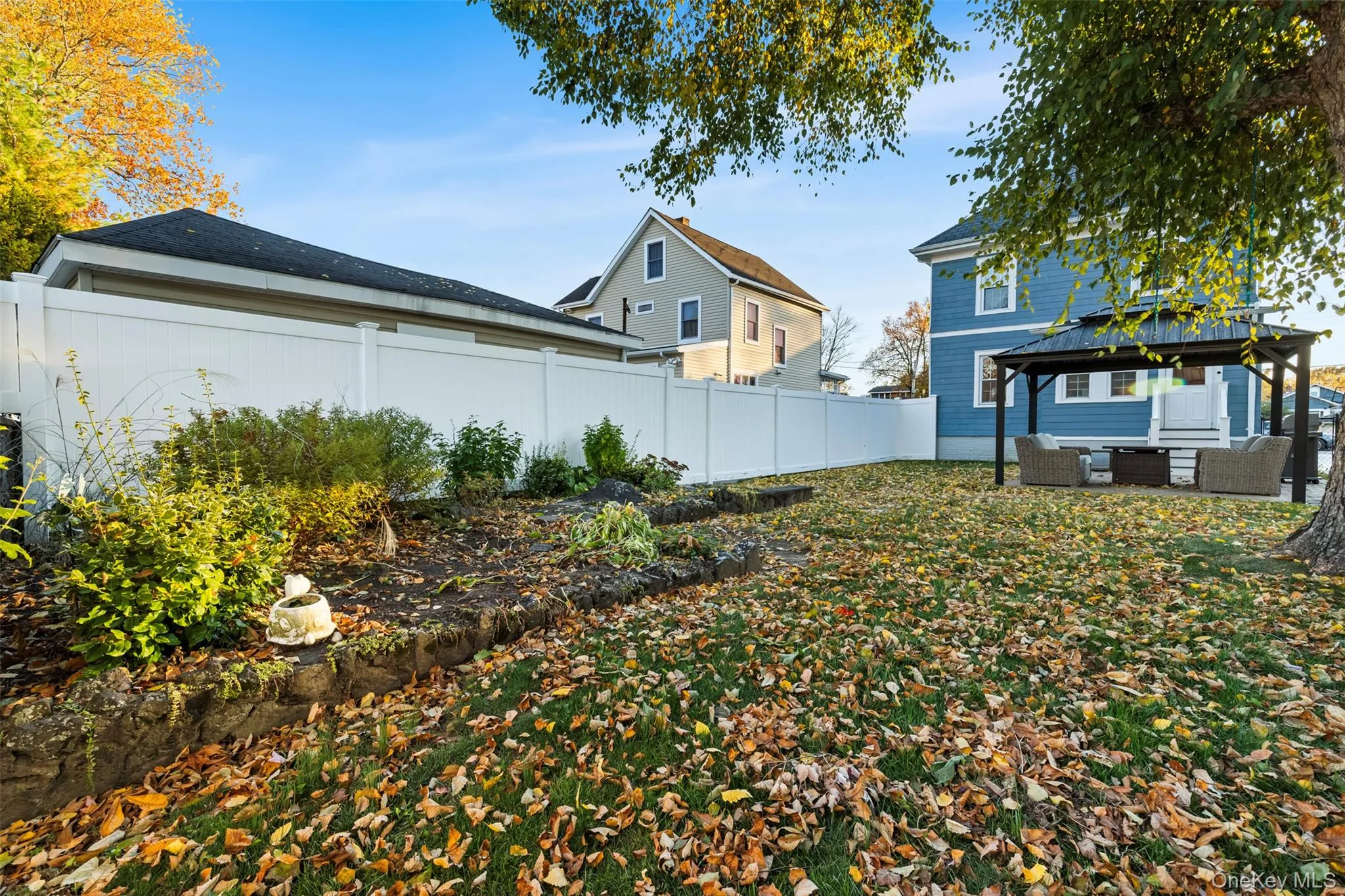Fenced backyard featuring a gazebo, a patio area, and an outdoor living space Fenced backyard featuring a gazebo, a patio area, and an outdoor living space