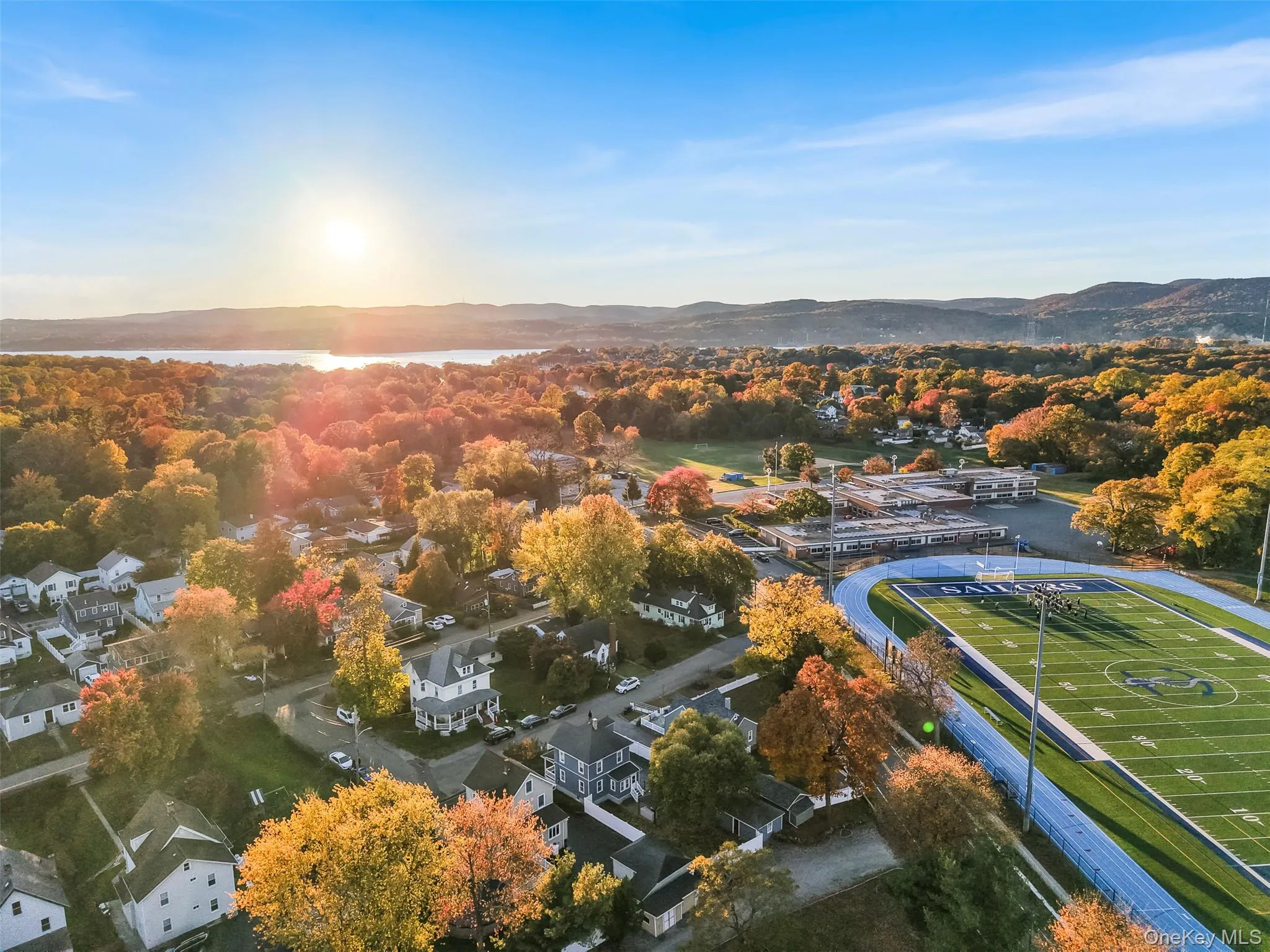 Aerial perspective of suburban area featuring a water and mountain view Aerial perspective of suburban area featuring a water and mountain view