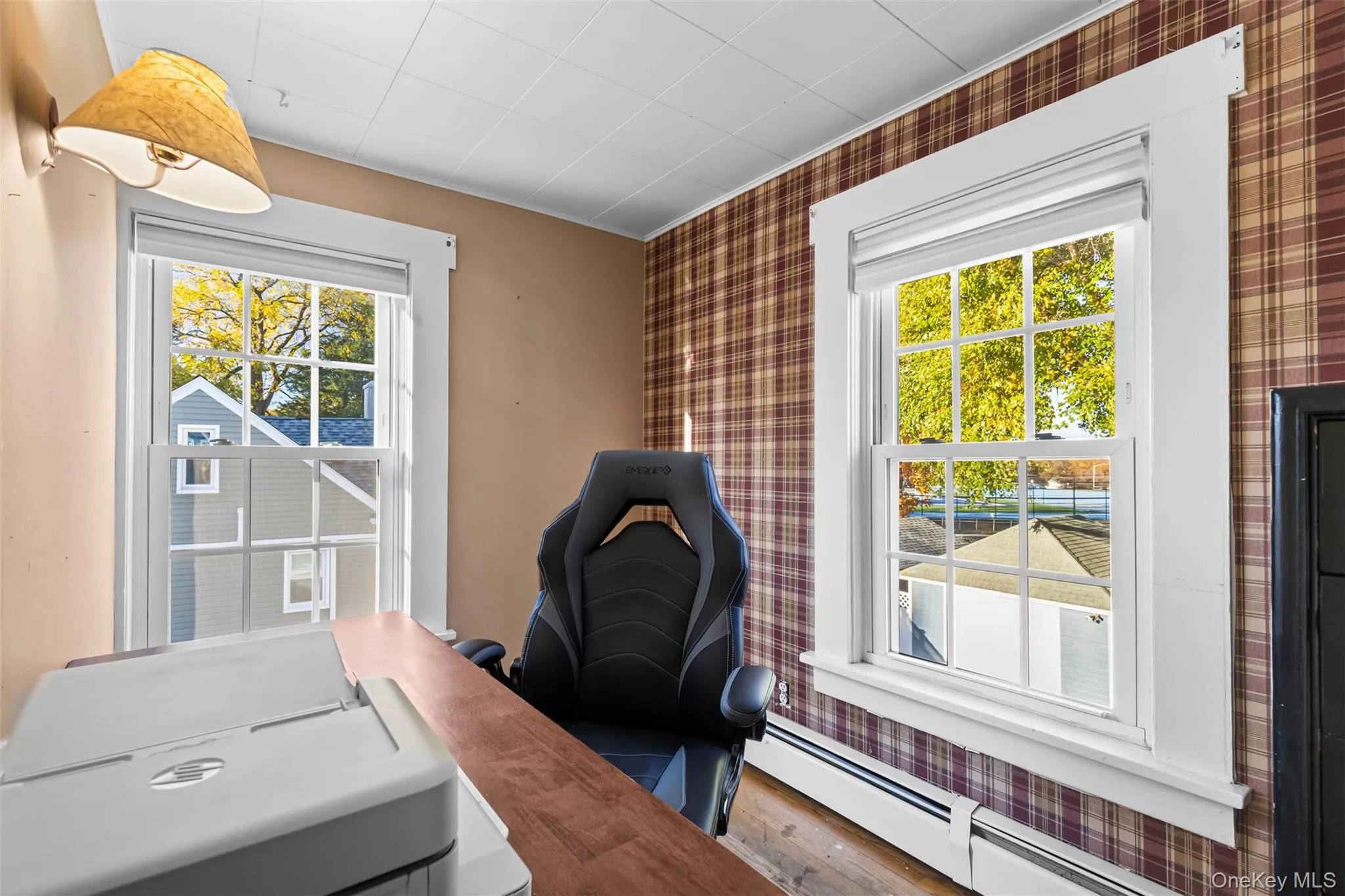 Office area featuring baseboard heating and wood finished floors Office area featuring baseboard heating and wood finished floors