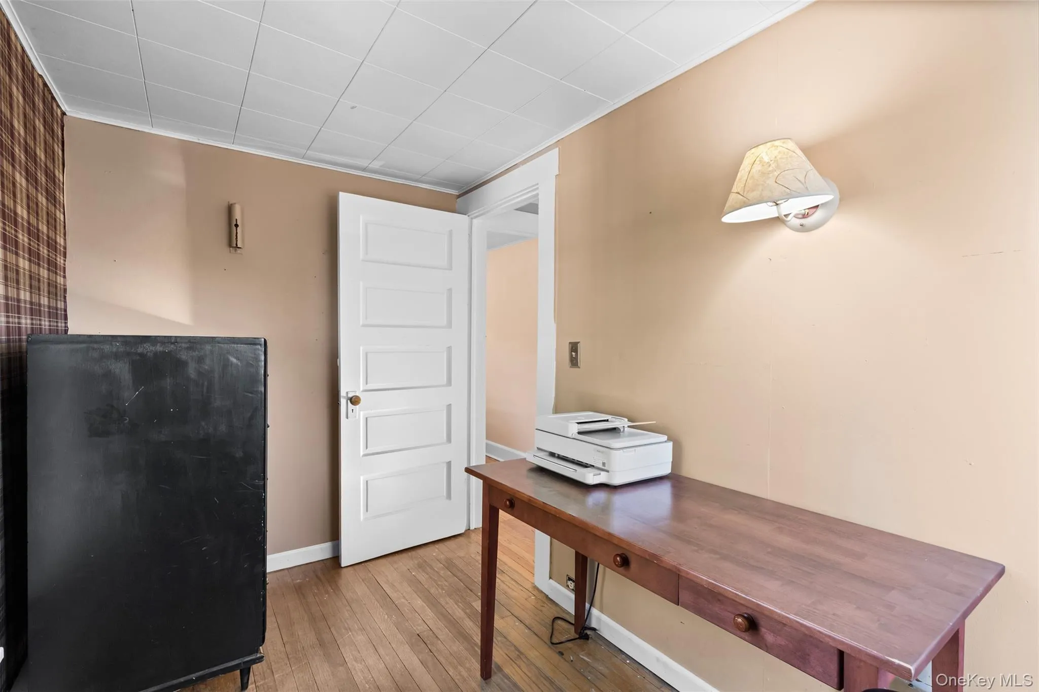 Office featuring hardwood / wood-style flooring, a paneled ceiling, and ornamental molding Office featuring hardwood / wood-style flooring, a paneled ceiling, and ornamental molding