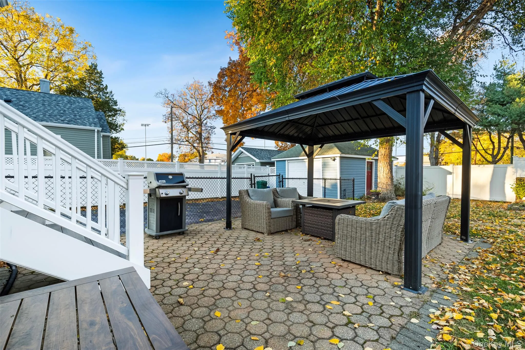 Fenced backyard with a patio area, an outdoor living space, a gazebo, area for grilling, and a storage unit Fenced backyard with a patio area, an outdoor living space, a gazebo, area for grilling, and a storage unit