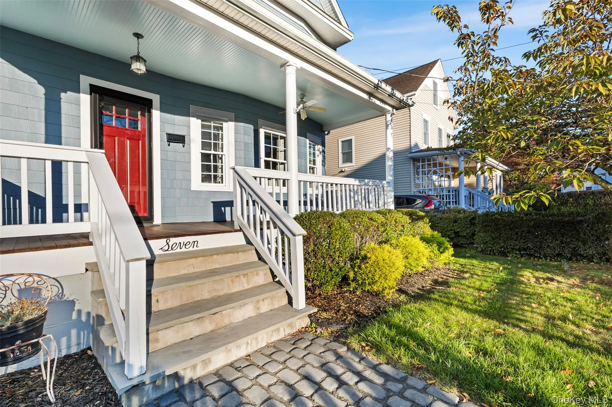 Doorway to property featuring a yard and covered porch Doorway to property featuring a yard and covered porch