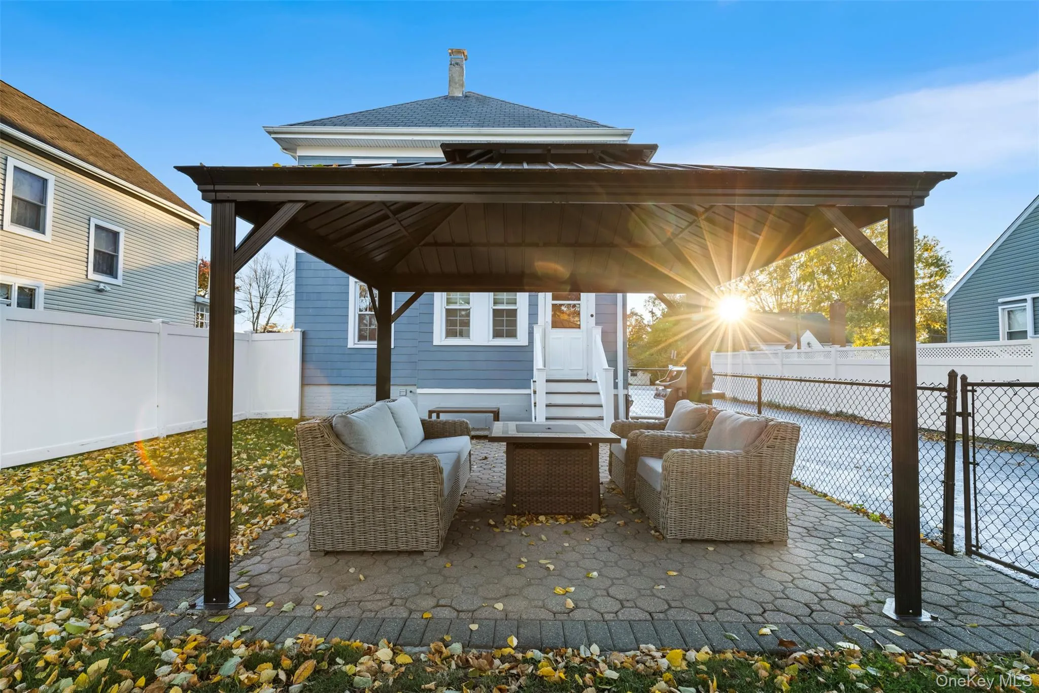 Fenced backyard with a patio area, a gazebo, and an outdoor living space Fenced backyard with a patio area, a gazebo, and an outdoor living space