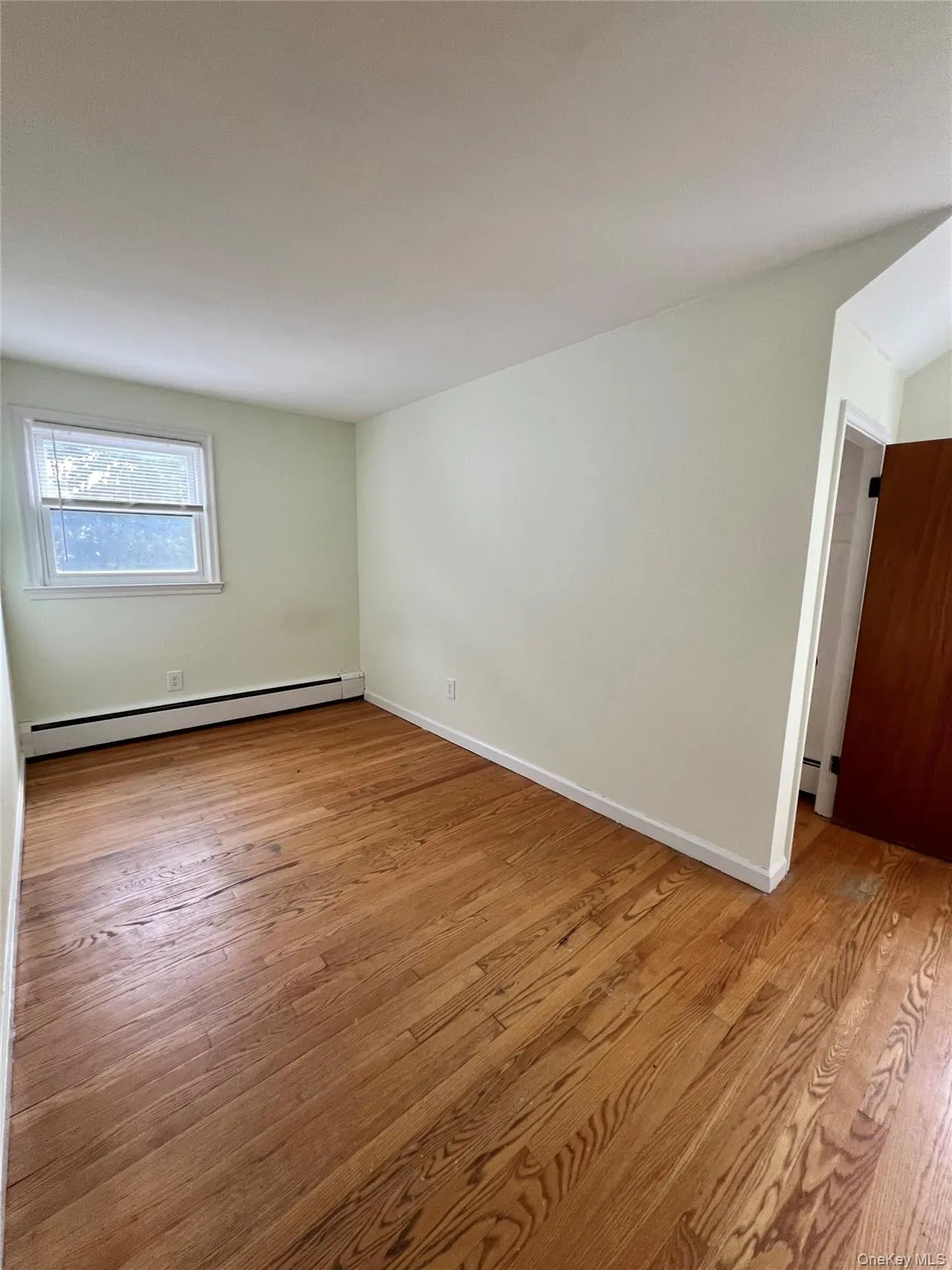 large 2nd bed queen room flooring and a baseboard radiator large 2nd bed queen room flooring and a baseboard radiator