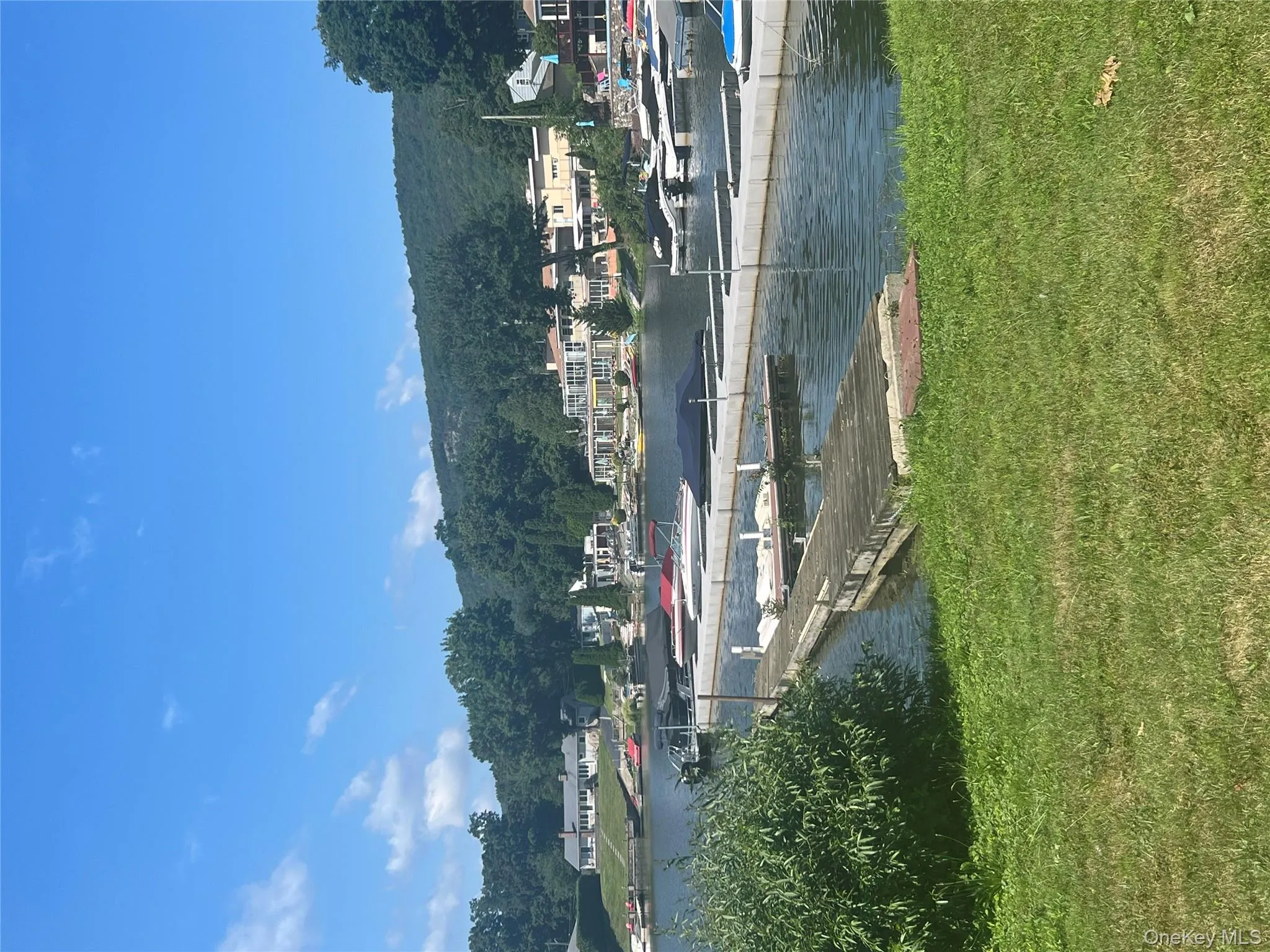 Dock area featuring a water view and a lawn Dock area featuring a water view and a lawn
