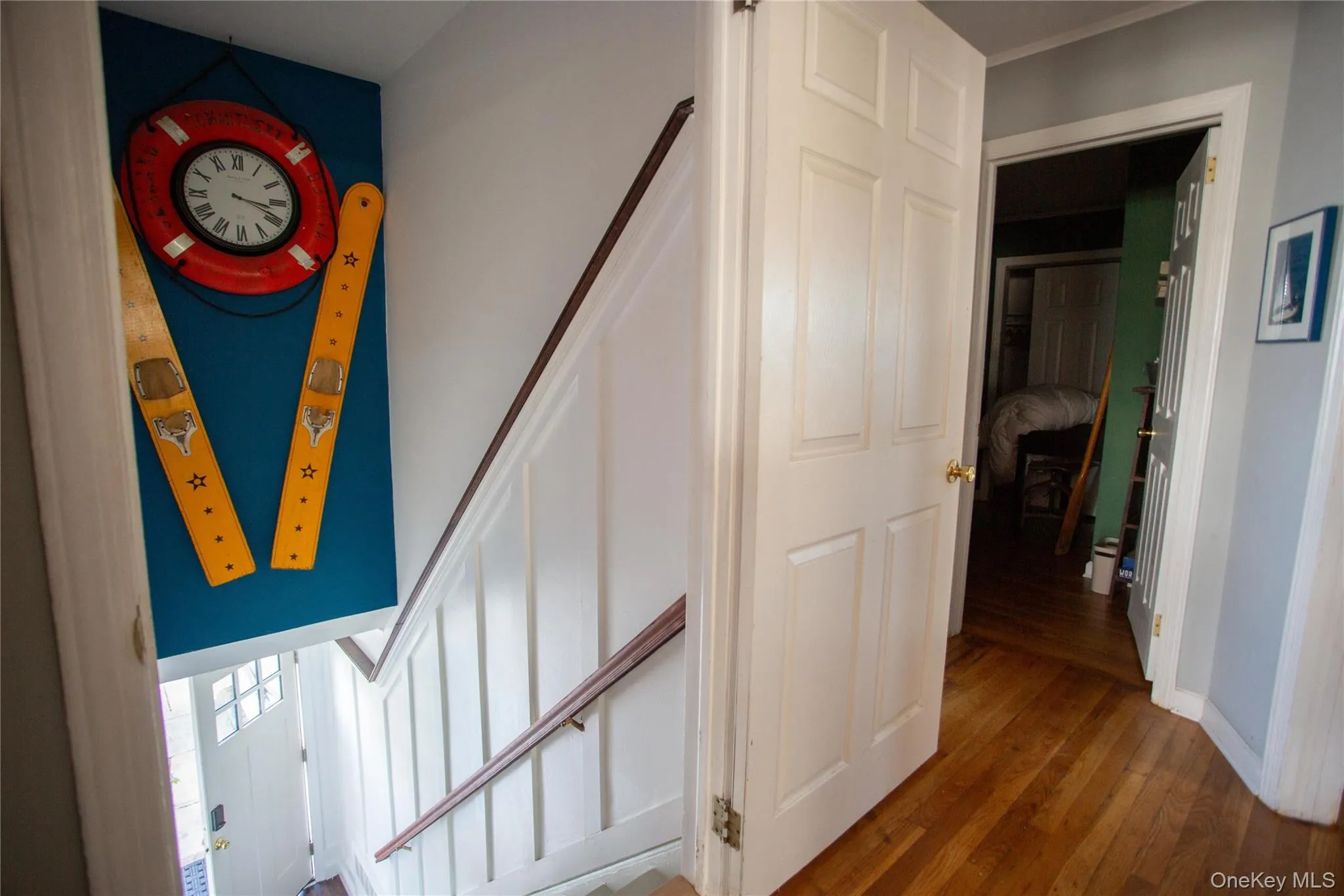 Stairs featuring wood finished floors and baseboards Stairs featuring wood finished floors and baseboards