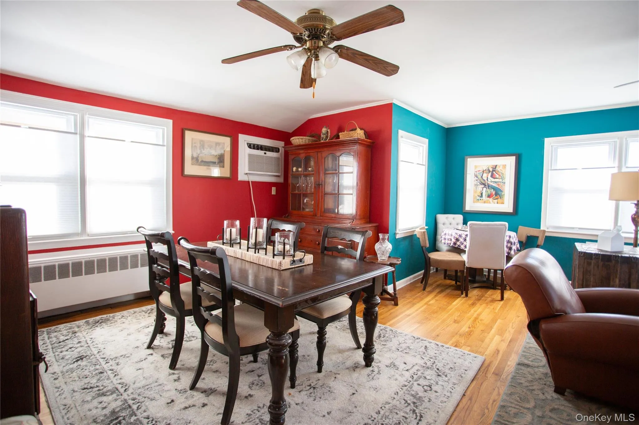 Dining room with light wood-type flooring, radiator heating unit, healthy amount of natural light, ceiling fan, and crown molding Dining room with light wood-type flooring, radiator heating unit, healthy amount of natural light, ceiling fan, and crown molding