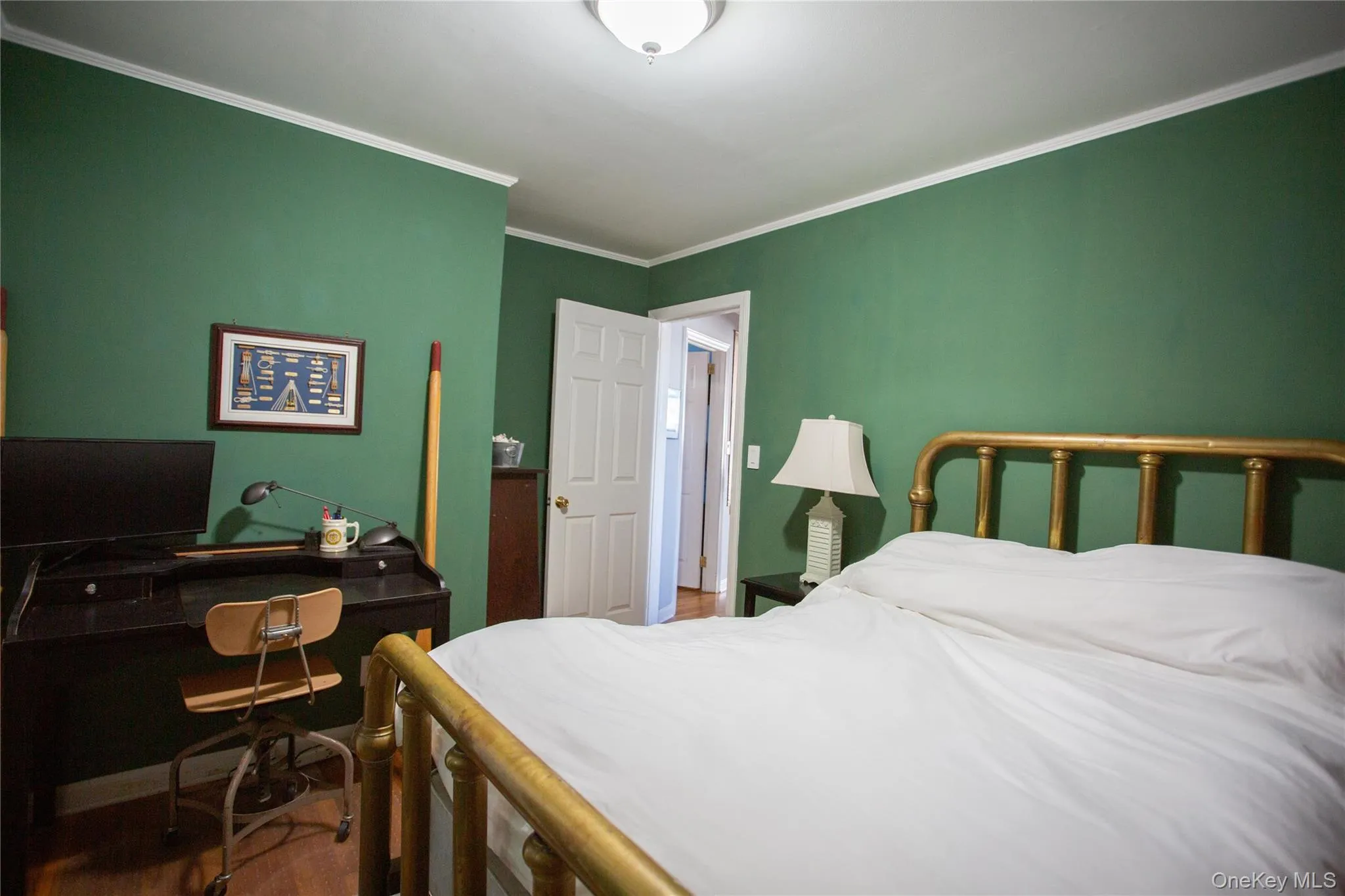 Bedroom featuring ornamental molding and an office area Bedroom featuring ornamental molding and an office area