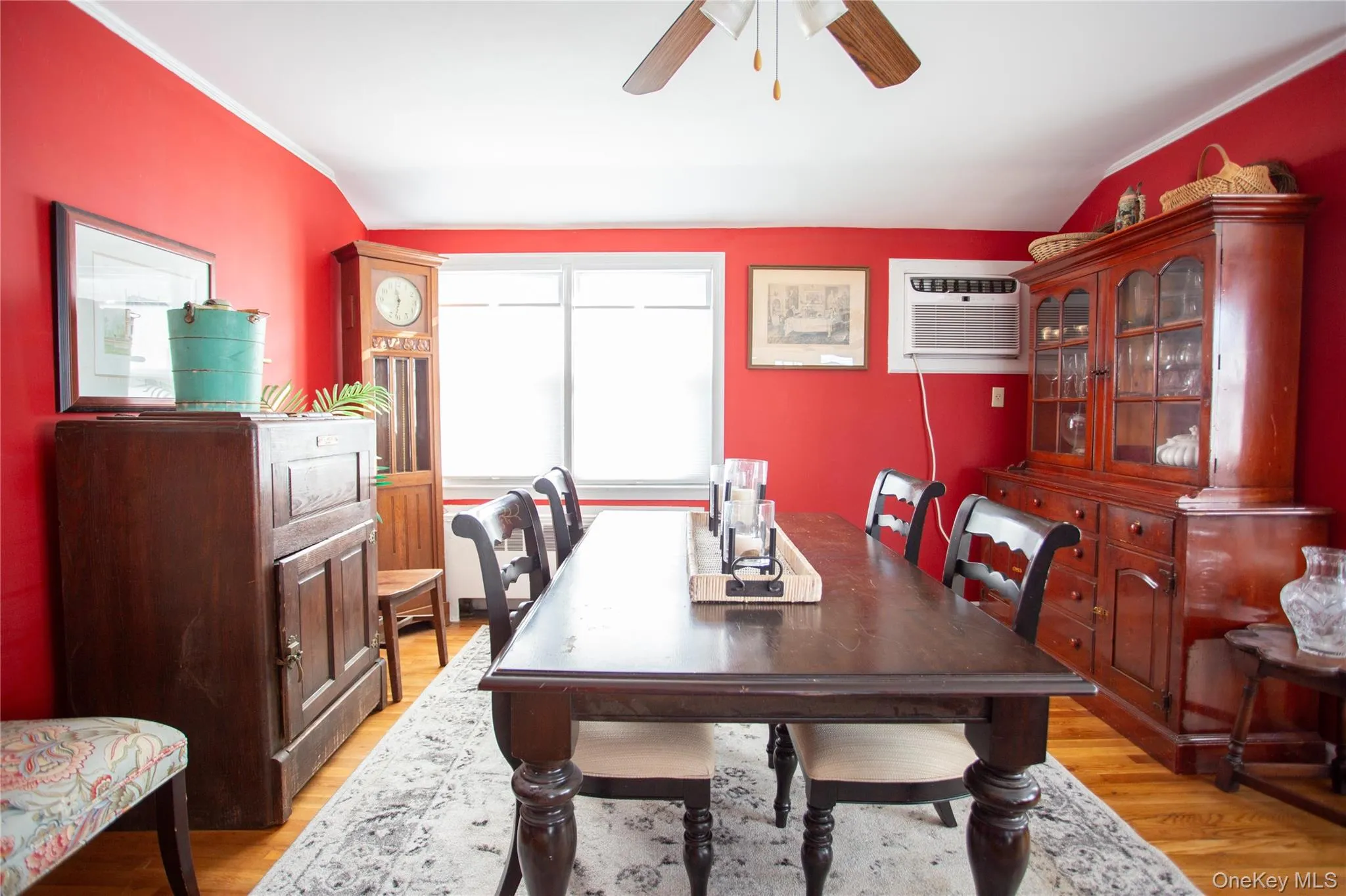 Dining room with light wood-style flooring, a wall unit AC, a ceiling fan, and crown molding Dining room with light wood-style flooring, a wall unit AC, a ceiling fan, and crown molding