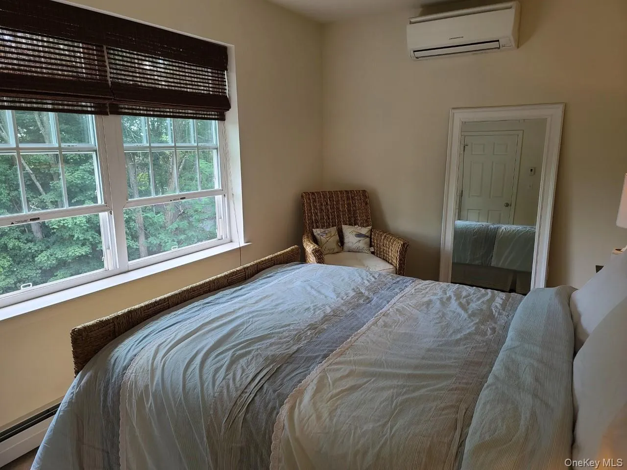 Bedroom featuring a wall mounted air conditioner and baseboard heating Bedroom featuring a wall mounted air conditioner and baseboard heating