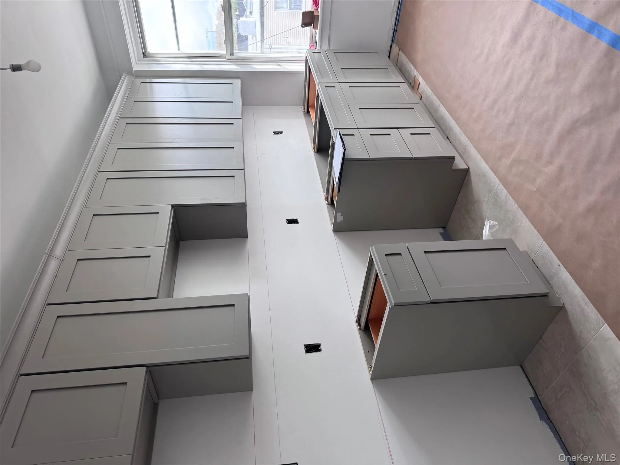 Kitchen featuring gray cabinets and light tile patterned floors Kitchen featuring gray cabinets and light tile patterned floors