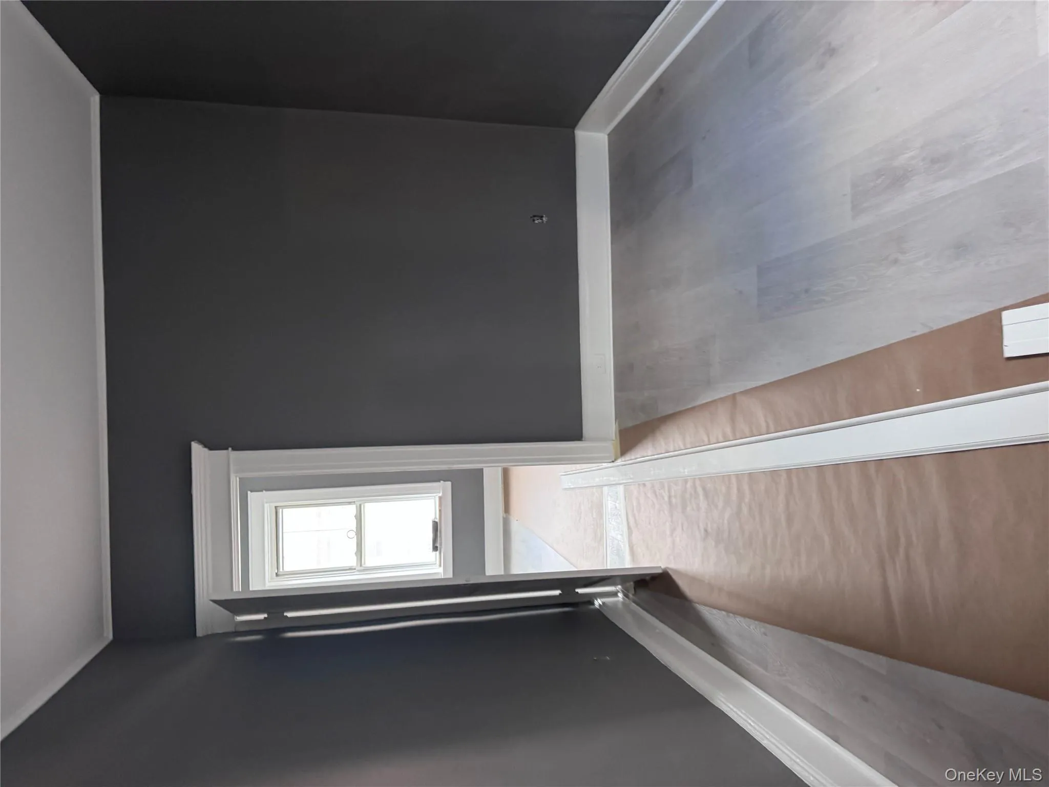 Empty room with light wood finished floors and crown molding Empty room with light wood finished floors and crown molding