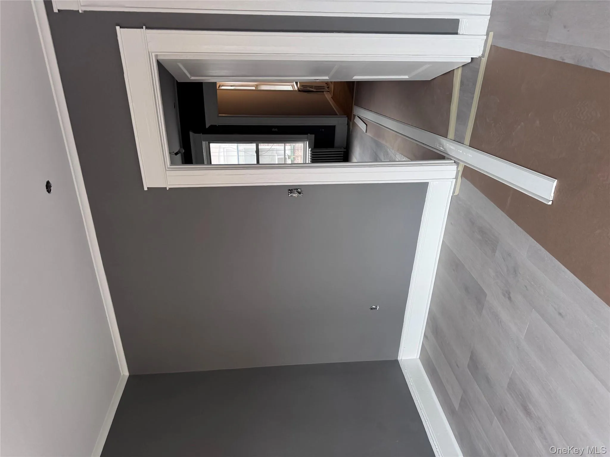 Empty room with wood finished floors, crown molding, and radiator Empty room with wood finished floors, crown molding, and radiator