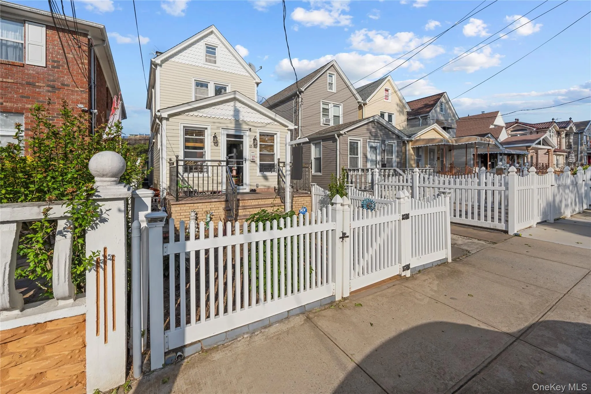 View of front of house featuring a gate, a fenced front yard, and a residential view View of front of house featuring a gate, a fenced front yard, and a residential view