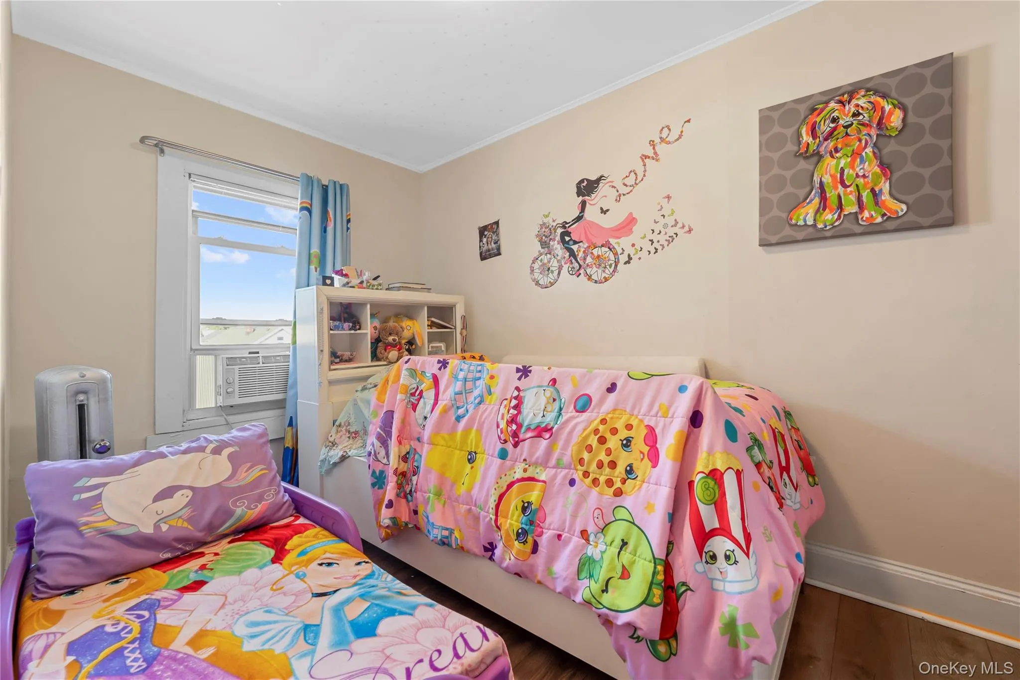 Bedroom with ornamental molding, wood finished floors, and cooling unit Bedroom with ornamental molding, wood finished floors, and cooling unit