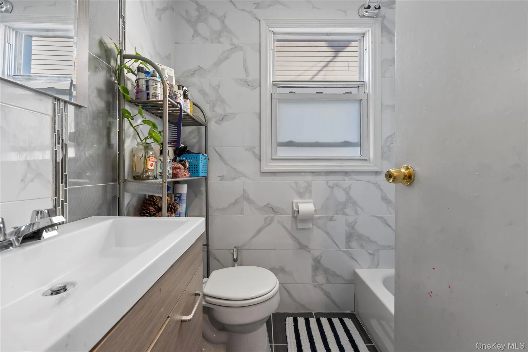 Full bath with tile walls, vanity, and a tub to relax in Full bath with tile walls, vanity, and a tub to relax in