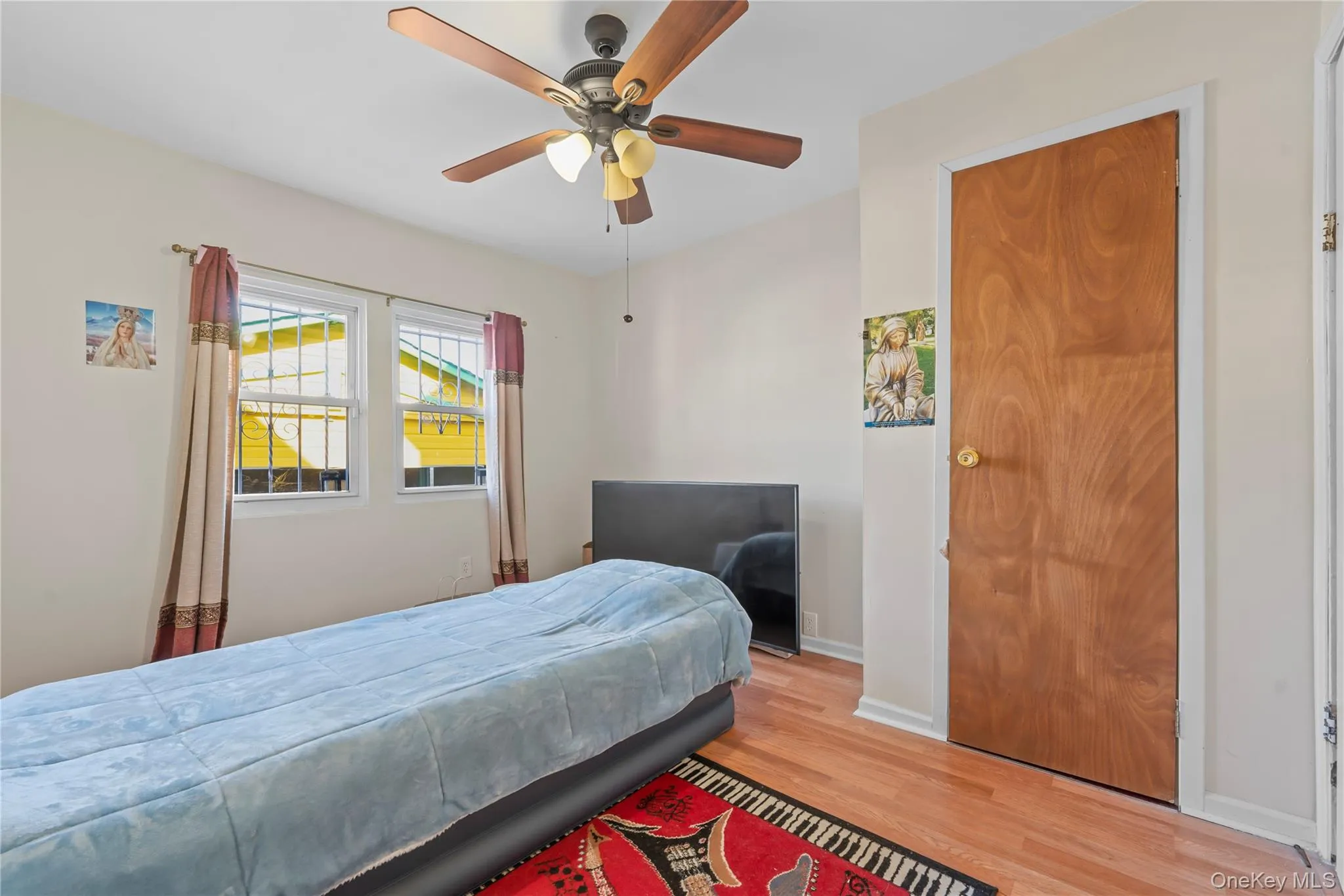 Bedroom featuring wood finished floors and a ceiling fan Bedroom featuring wood finished floors and a ceiling fan