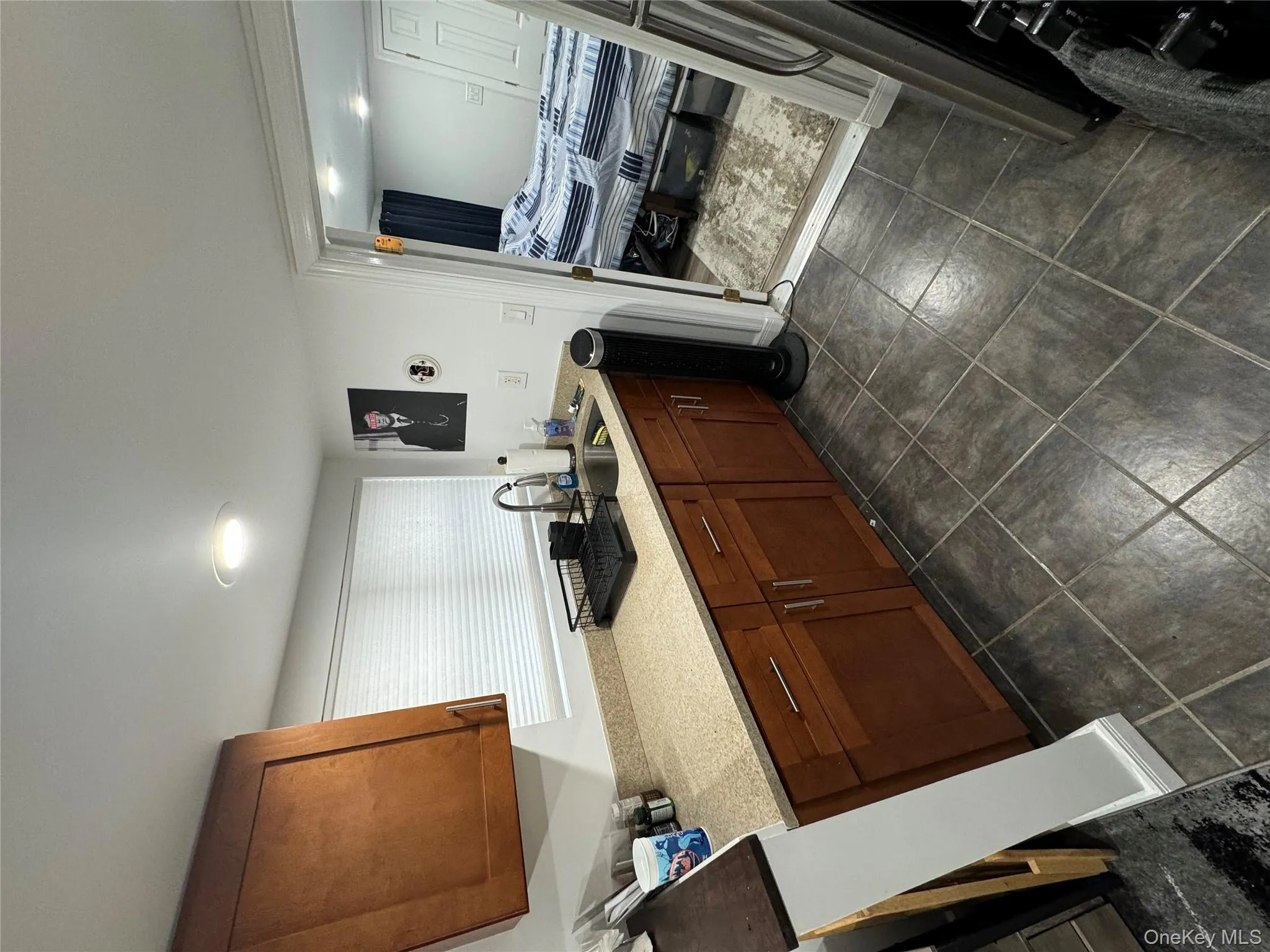 Kitchen featuring brown cabinets and light stone counters Kitchen featuring brown cabinets and light stone counters