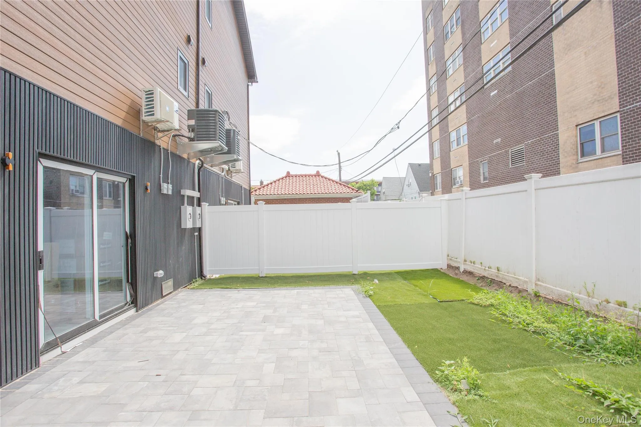 Fenced backyard with a patio area Fenced backyard with a patio area