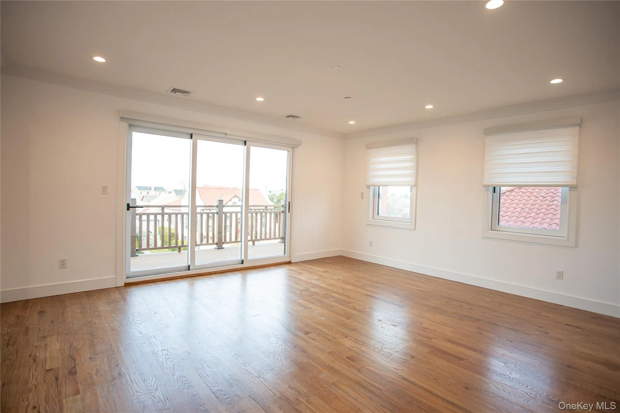 Unfurnished room with ornamental molding, wood finished floors, and recessed lighting Unfurnished room with ornamental molding, wood finished floors, and recessed lighting