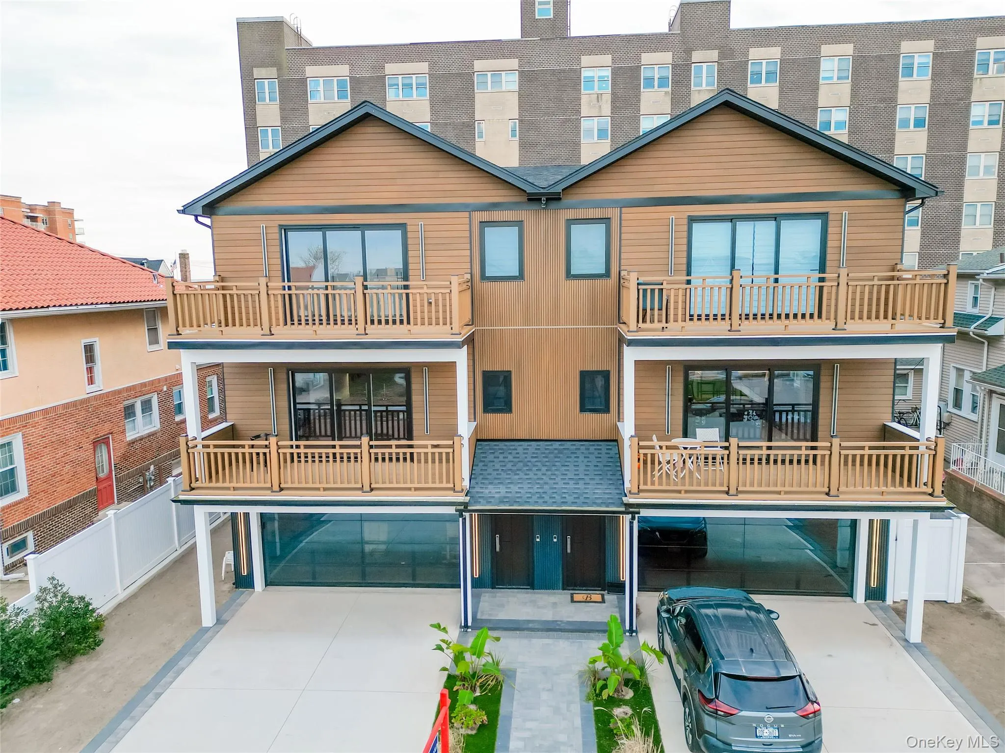 View of front of property with driveway, a garage, and a balcony View of front of property with driveway, a garage, and a balcony