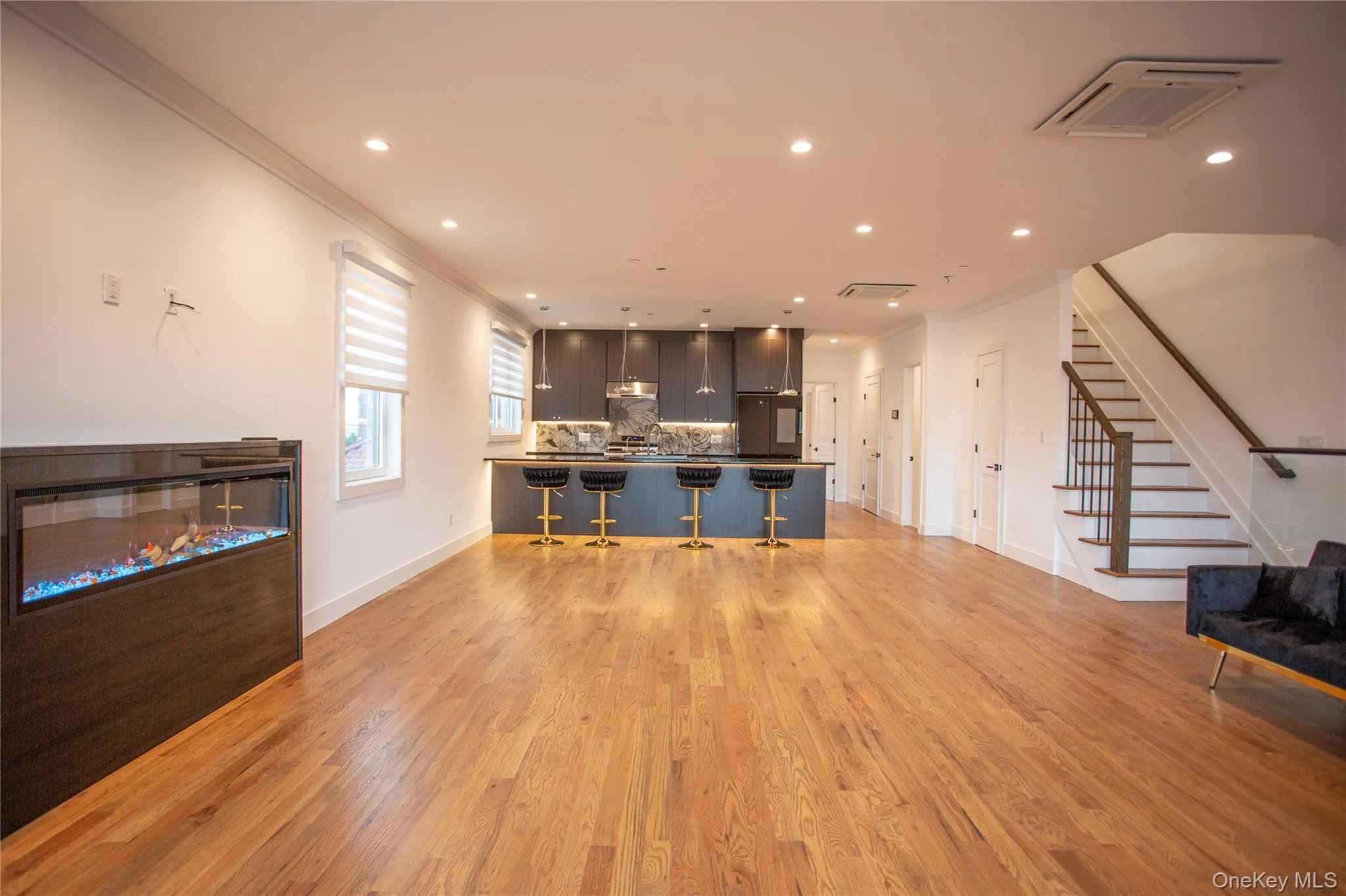 Kitchen with open floor plan, ornamental molding, a kitchen breakfast bar, backsplash, and recessed lighting Kitchen with open floor plan, ornamental molding, a kitchen breakfast bar, backsplash, and recessed lighting