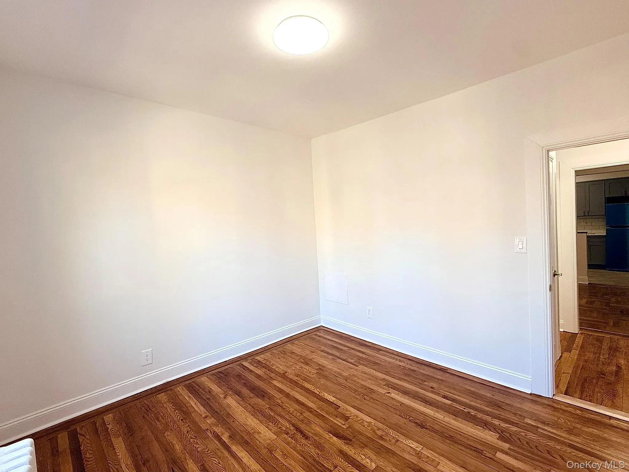 Spare room with dark wood-style flooring Spare room with dark wood-style flooring