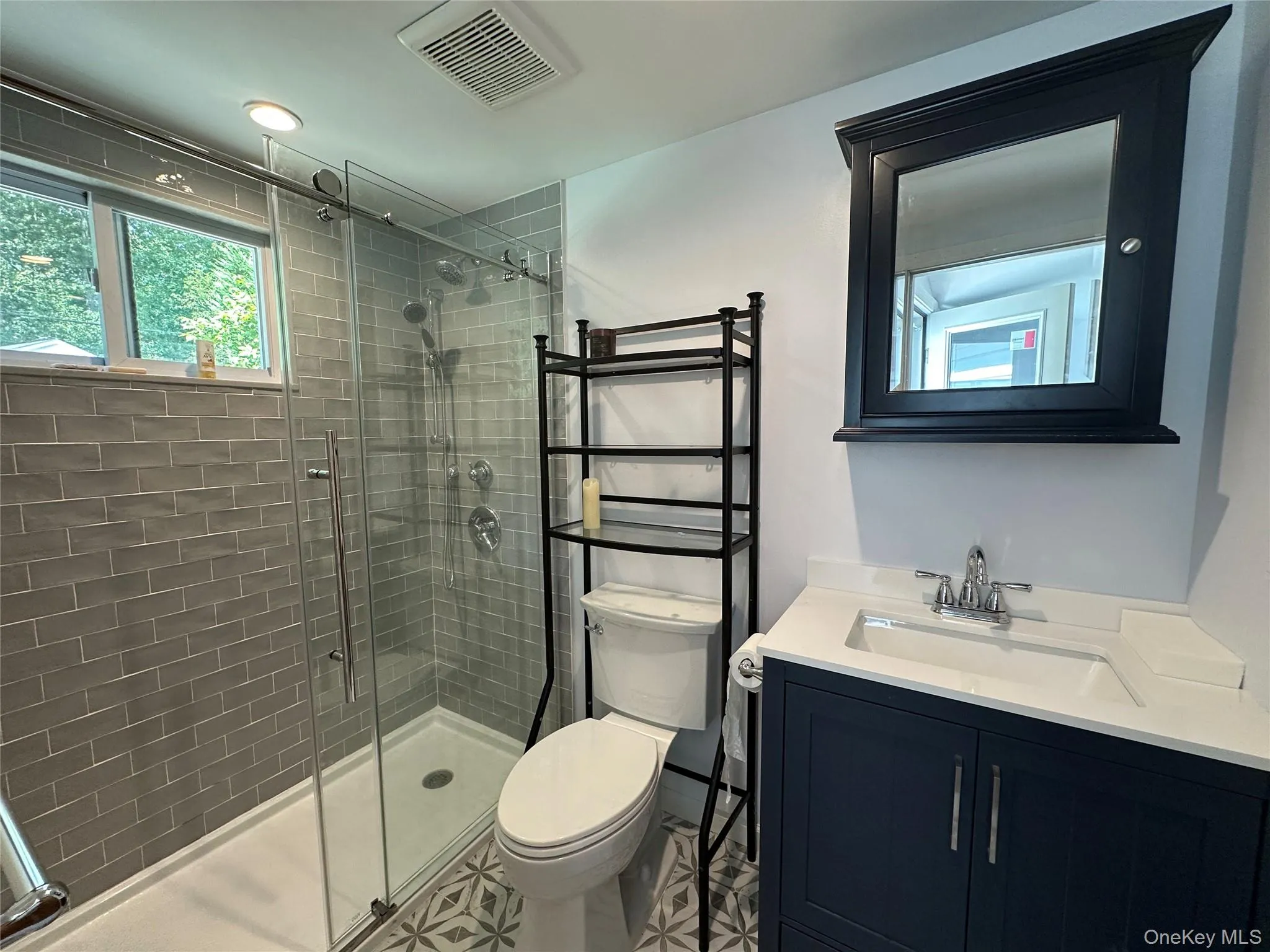 Bathroom with vanity and a shower stall Bathroom with vanity and a shower stall