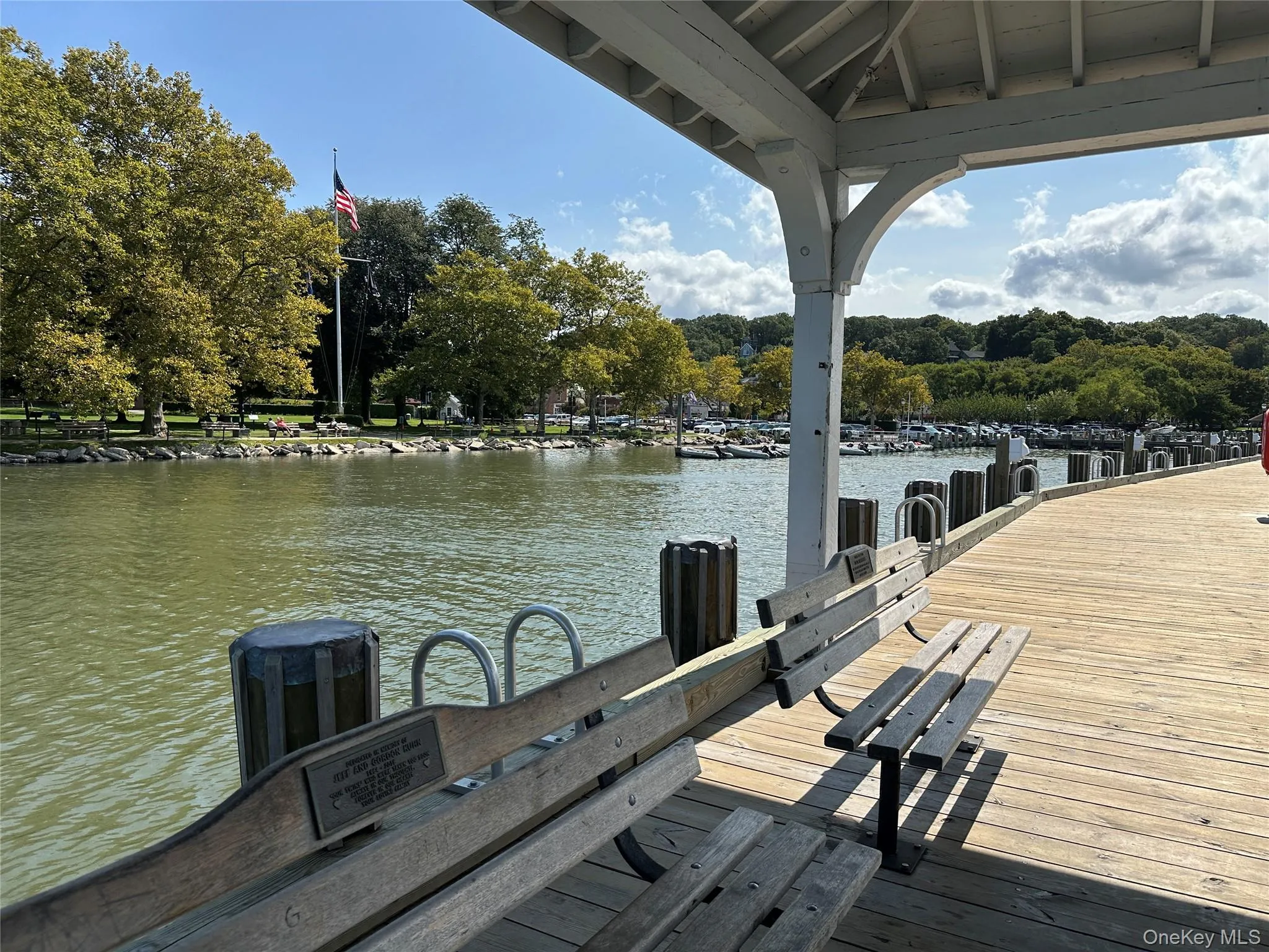 Dock featuring a water view and view of scattered trees Dock featuring a water view and view of scattered trees