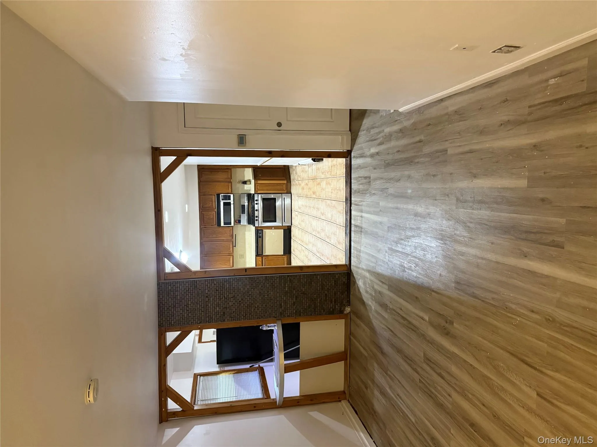 Unfurnished living room with light wood-style floors and baseboards Unfurnished living room with light wood-style floors and baseboards