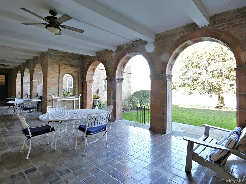 View of patio featuring a ceiling fan and outdoor dining area View of patio featuring a ceiling fan and outdoor dining area