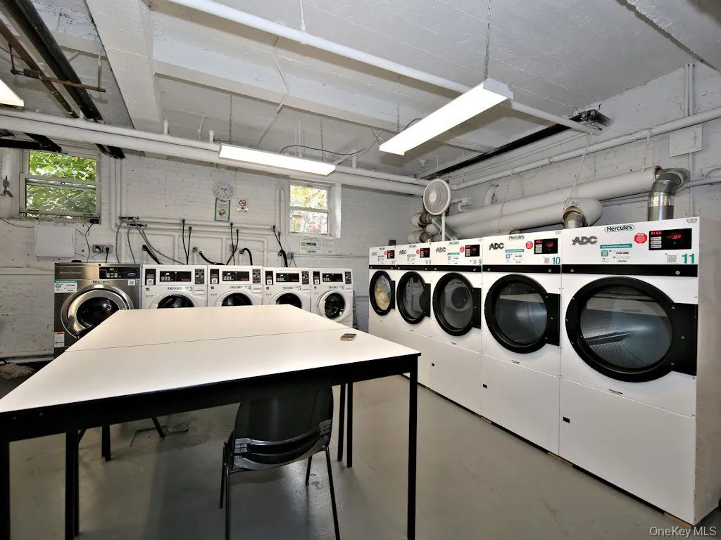 Community laundry room featuring washing machine and clothes dryer Community laundry room featuring washing machine and clothes dryer