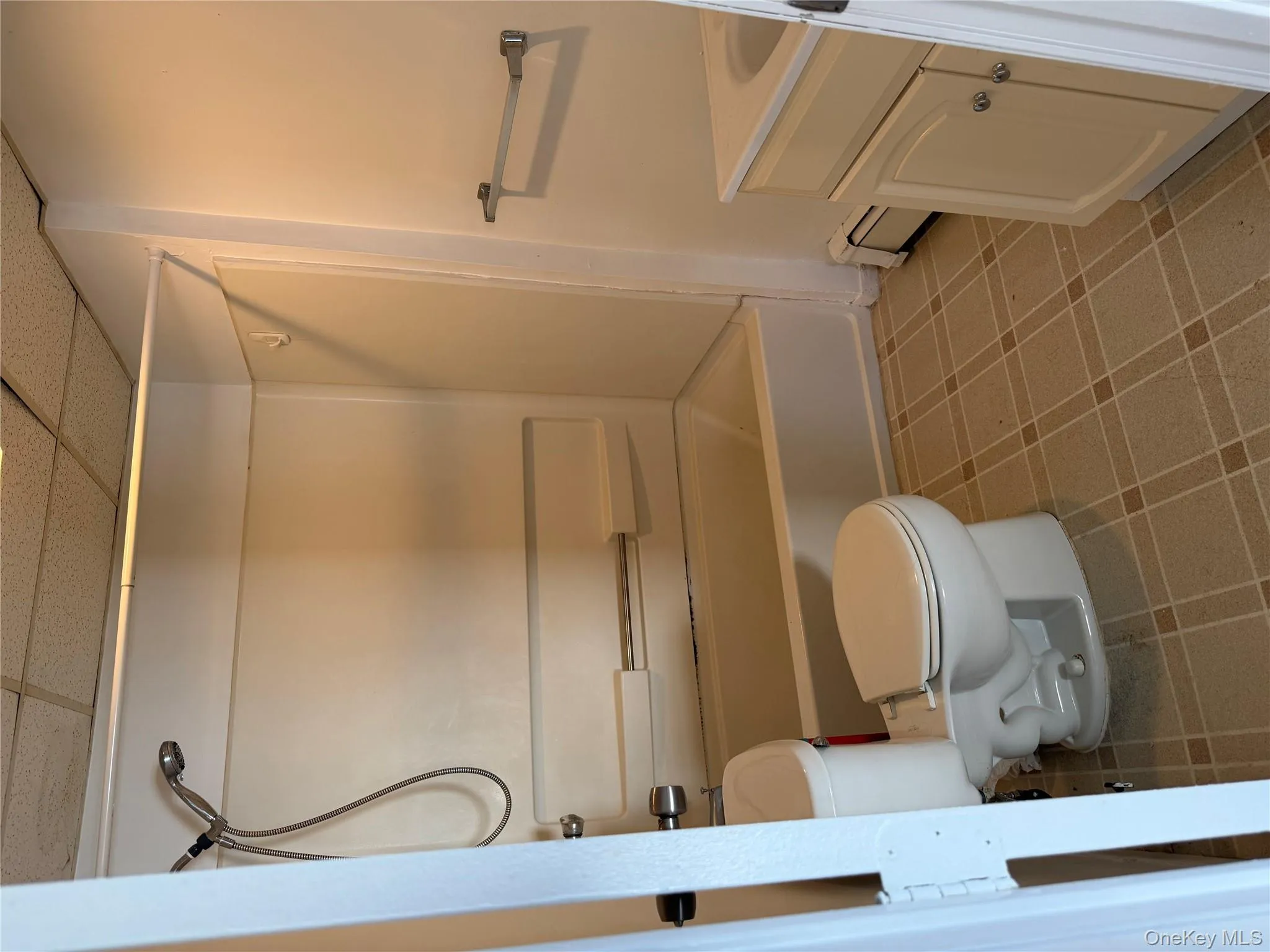 Full bathroom with a paneled ceiling, vanity, baseboard heating, and shower / washtub combination Full bathroom with a paneled ceiling, vanity, baseboard heating, and shower / washtub combination