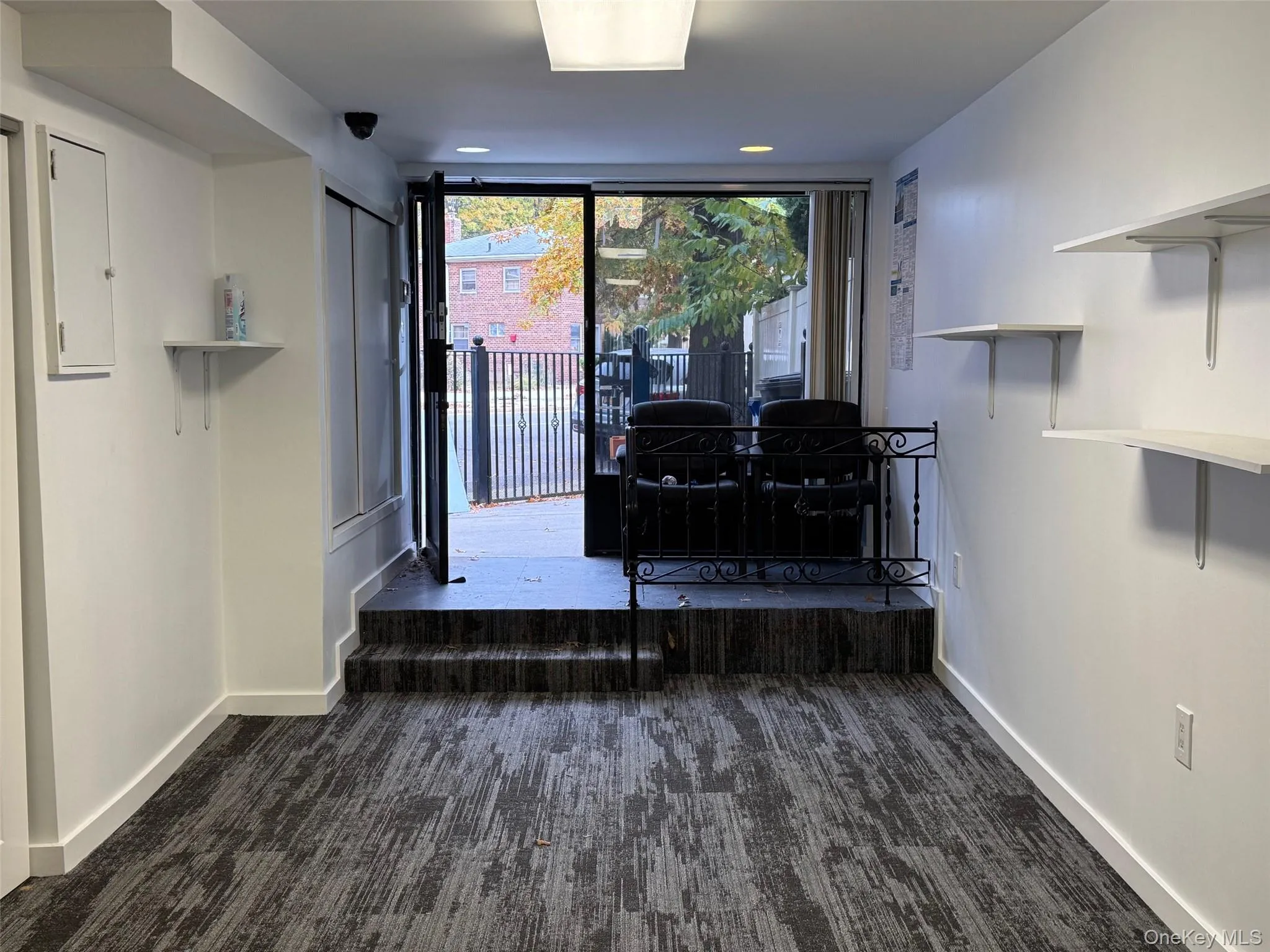 Foyer featuring dark carpet and electric panel Foyer featuring dark carpet and electric panel