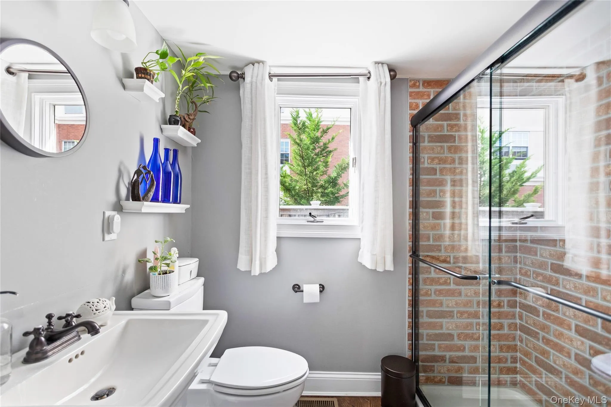 Full bath with healthy amount of natural light and a shower stall Full bath with healthy amount of natural light and a shower stall