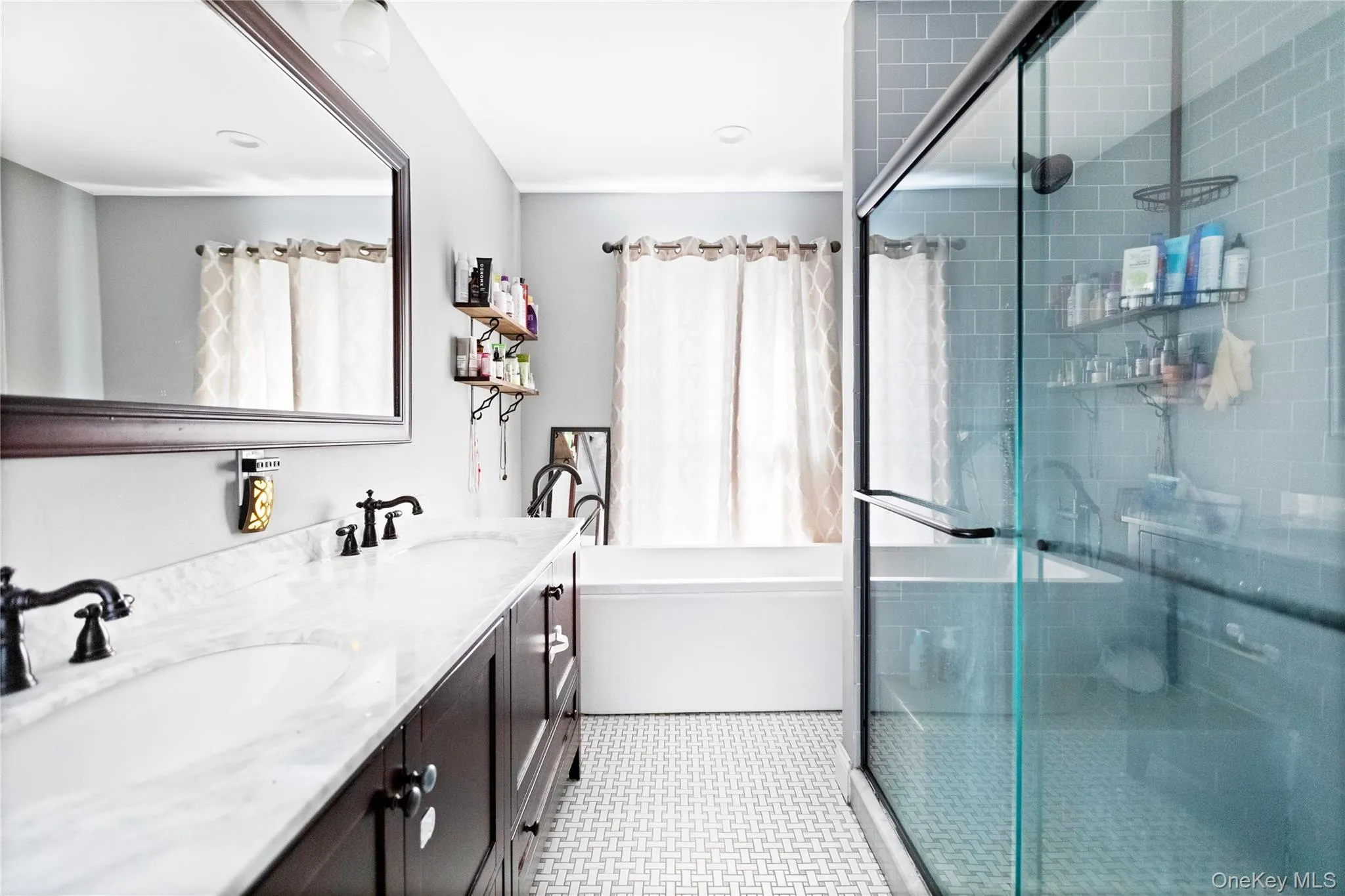 Bathroom with double vanity, a shower stall, and a tub Bathroom with double vanity, a shower stall, and a tub